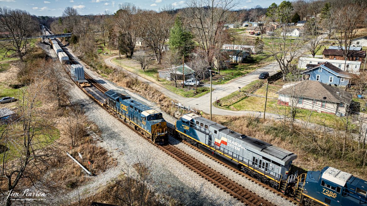 CSX Seaboard System Heritage unit 1982 southbound leads hot intermodal, CSX I025, as they meet northbound M512 with a high and wide loaded transformer, at Nortonville, Kentucky as it heads south on the Henderson Subdivision on March 4th, 2024.

According to Wikipedia: The Seaboard System Railroad, Inc. (reporting mark SBD) was a US Class I railroad that operated from 1982 to 1986.

Since the late 1960s, Seaboard Coast Line Industries had operated the Seaboard Coast Line and its sister railroads, notably the Louisville & Nashville and Clinchfield, as the “Family Lines System”. In 1980, SCLI merged with the Chessie System to create the holding company CSX Corporation; two years later, CSX merged with the Family Lines railroads to create the Seaboard System Railroad.

In 1986, Seaboard renamed itself CSX Transportation, which absorbed the Chessie System’s two major railroads the following year.

Tech Info: DJI Mavic 3 Classic Drone, RAW, 22mm, f/2.8, 1/1250, ISO 110.

#trainphotography #railroadphotography #trains #railways #jimpearsonphotography #trainphotographer #railroadphotographer #csxt #dronephoto #trainsfromadrone #trending #CSXHeritageUnit