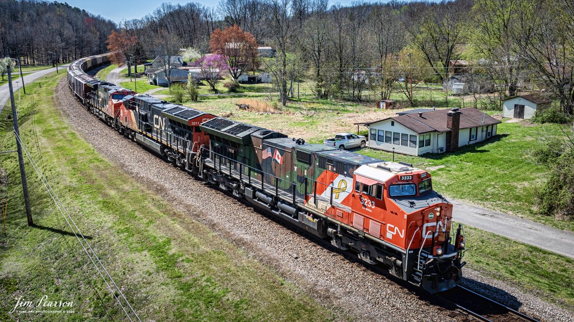 Canadian National (CN) locomotive 3233 (Support our Troops) leads B229-13 as they head north through the curve at Mortons Gap, Kentucky a beautiful spring day, on the CSX Henderson Subdivision, March 16th, 2024.

From a CN Press Release: “CN’s two tribute locomotives (CN 3233 & 3015) pay homage to veterans and active military men and women across North America. Their custom design represents the proud footprint we have established across our network and our deep recognition for the veterans who live and work in the communities our trains pass through every day. 

Tech Info: DJI Mavic 3 Classic Drone, RAW, 22mm, f/2.8, 1/2000, ISO 140.

#trainphotography #railroadphotography #trains #railways #jimpearsonphotography #trainphotographer #railroadphotographer #csxt #dronephoto #trainsfromadrone #trending #csxhendersonsubdivision #cnrailway