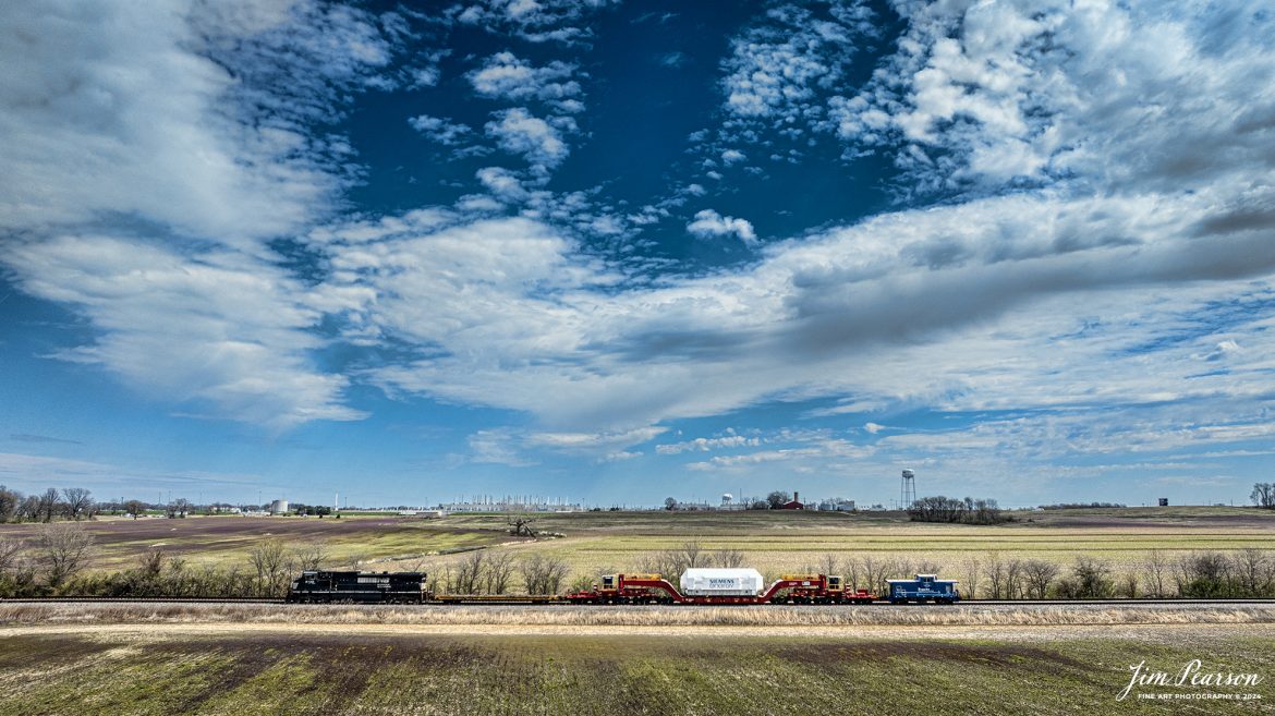 Norfolk Southern 3730 leads CSX S991 as they head north at King with an oversized Turbine load from Siemens Energy on a depressed flatbed as they pass the Toyota factory off in the distance at Princeton, Indiana, on the CSX CE&D Subdivision, on March 20th, 2024, with a Fracht Caboose bringing up the rear. It originated at Birmingham, AL and is headed for New Castle, PA. I caught this move just north of Evansville, IN and gave chase to Patoka, Indiana, so stay tuned as I’ll be posting more images of it next week!

Tech Info: DJI Mavic 3 Classic Drone, RAW, 22mm, f/2.8, 1/2500, ISO 100.

#trainphotography #railroadphotography #trains #railways #jimpearsonphotography #trainphotographer #railroadphotographer #csxt #dronephoto #trainsfromadrone #trending #csxcedsubdivision #norfolksouthern #trending