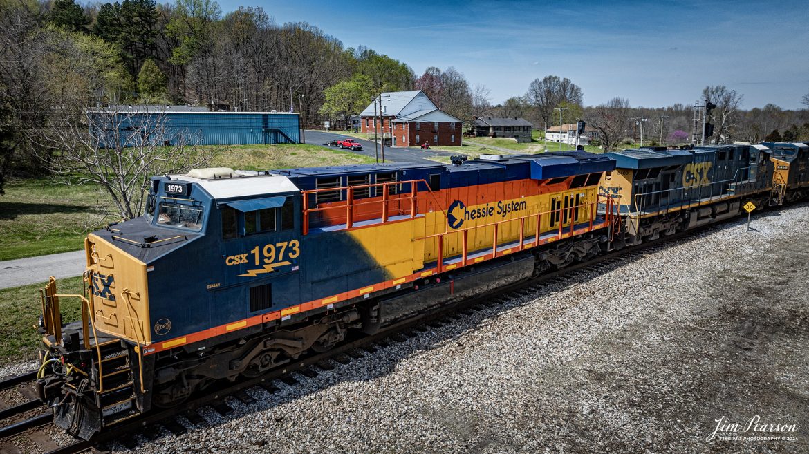 CSXT 1973, Chessie System Heritage Unit, leads CSX M647 as it pulls onto the main from the cutoff at Mortons Junction, Mortons Gap, Ky and continues south on the CSX Henderson Subdivision, on December 22, 2023. The Henderson Subdivision has seen a lot of CSX Heritage units the last week or so and hopefully there’ll be more in the future so I can capture and share them with you! I’ll be posting some videos of these moves in future Saturday Edited Videos so keep an eye out for them!

According to Wikipedia: The three railroads that would make up the Chessie System had been closely related since the 1960s. C&O had acquired controlling interest in B&O in 1962, and the two had jointly controlled WM since 1967.

Chessie System, Inc. was a holding company that owned the Chesapeake and Ohio Railway (C&O), the Baltimore and Ohio Railroad (B&O), the Western Maryland Railway (WM), and Baltimore and Ohio Chicago Terminal Railroad (B&OCT). Trains operated under the Chessie name from 1973 to 1987.

On November 1, 1980, Chessie System merged with Seaboard Coastline Industries to form CSX Corporation. Initially, the three Chessie System railroads continued to operate separately, even after Seaboard’s six Family Lines System railroads were merged into the Seaboard System Railroad on December 29, 1982. That began to change in 1983, when the WM was merged into the B&O. The Chessie image continued to be applied to new and re-painted equipment until July 1, 1986, when CSXT introduced its own paint scheme. In April 1987, the B&O was merged into the C&O. In August 1987, C&O merged into CSX Transportation, a 1986 renaming of the Seaboard System Railroad, and the Chessie System name was retired.

Tech Info: DJI Mavic 3 Classic Drone, RAW, 22mm, f/2.8, 1/2500, ISO 110.

#trainphotography #railroadphotography #trains #railways #jimpearsonphotography #trainphotographer #railroadphotographer #csxt #dronephoto #trainsfromadrone #csx #csxheritageunit #trending