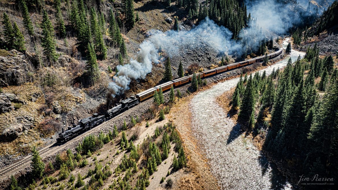 Denver and Rio Grande Western double header steam locomotives 473 and 493 pull one of several daily passenger trains north through Deadwood Gulch, as they approach Silverton, Colorado on October 15th, 2023.

According to Wikipedia: The Durango and Silverton Narrow Gauge Railroad, often abbreviated as the D&SNG, is a 3 ft (914 mm) narrow-gauge heritage railroad that operates on 45.2 mi (72.7 km) of track between Durango and Silverton, in the U.S. state of Colorado. The railway is a federally designated National Historic Landmark and was also designated by the American Society of Civil Engineers as a National Historic Civil Engineering Landmark in 1968.

Tech Info: DJI Mavic 3 Classic Drone, RAW, 22mm, f/2.8, 1/1600, ISO 200.