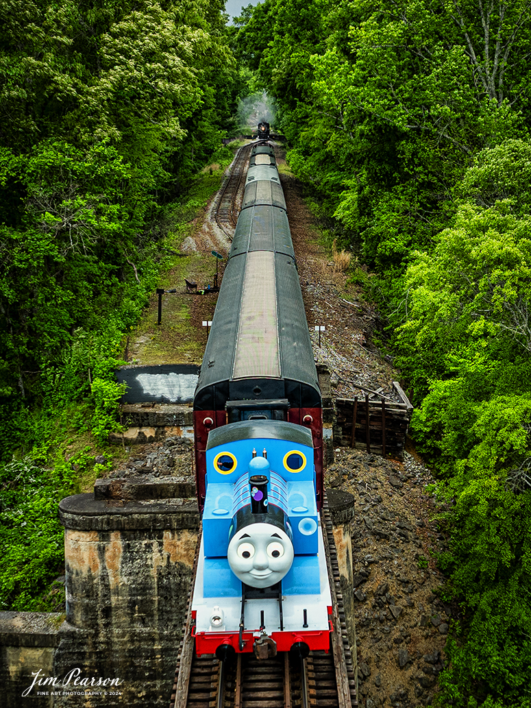 Thomas the Tank Engine prepares to meet  Southern Railroad 630 at the siding just before the Chickamauga Creek Bridge at the Tennessee Valley Railroad Museum at west Chattanooga, Tennessee, on April 27th, 2024.

According to Wikipedia: Thomas the Tank Engine is an anthropomorphised fictional tank locomotive in the British Railway Series books by Wilbert Awdry and his son, Christopher, published from 1945. He became the most popular and famous character in the series, and is the titular protagonist in the accompanying television adaptation series Thomas & Friends and its reboot Thomas & Friends: All Engines Go.

All of the vehicles in The Railway Series were based on prototypical engines; Thomas's basis is the LB&SCR E2 class. Thomas first appeared in 1946 in the second book in the series, Thomas the Tank Engine, and was the focus of the four short stories contained within. In The Railway Series and early episodes of Thomas & Friends, Thomas's best friends are Percy and Toby, though he is also close friends with Edward. Later episodes of Thomas & Friends have Thomas in a trio with James and Percy, and Percy is known as his best friend.

In 1979, British writer and producer Britt Allcroft came across the books, and arranged a deal to bring the stories to life as the TV series Thomas the Tank Engine & Friends (later simplified to Thomas & Friends). The programme became an award-winning hit around the world, with a vast range of spin-off commercial products.

Thomas now travels the world to delight children of all ages!

Tech Info: DJI Mavic 3 Classic Drone, RAW, 24mm, f/2.8, 1/640, ISO 100.