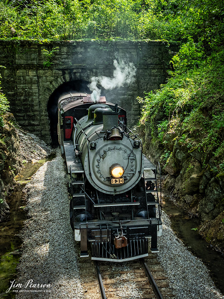 Tennessee Valley Railroad Museum’s steam locomotive Southern Railway 630 exits Missionary Ridge Tunnel as it approaches East Chattanooga, Tennessee with a trainload of passengers, on April 28th, 2024. 

According to Wikipedia: Southern Railway 630 is a 2-8-0 "Consolidation" type steam locomotive built in February 1904 by the American Locomotive Company (ALCO) of Richmond, Virginia for the Southern Railway as a member of the Ks-1 class. It is currently owned and operated by the Tennessee Valley Railroad Museum in Chattanooga, Tennessee where it resides today for use on excursion trains.

According to the Tennessee River Valley Tourism site: Tennessee Valley Railroad Museum's passenger trains run on an historic route which includes Missionary Ridge Tunnel, completed in 1858 and on the National Register of Historic Places. The tunnel is the primary reason TVRM runs on the three-mile section of the former Southern Railway. As railroad equipment grew too large to pass through, the single-track tunnel became a traffic jam for an other wise double-track railroad. Southern Railway abandoned the three-mile portion of the line and built a new section around the end of Missionary Ridge, avoiding the tunnel altogether. TVRM restored rails through the tunnel in 1971 and continues to use the pre-Civil War Tunnel daily.

Tech Info: DJI Mavic 3 Classic Drone, RAW, 24mm, f/2.8, 1/400, ISO 110.

#trainphotography #railroadphotography #trains #railways #trainphotographer #railroadphotographer #jimpearsonphotography #PassengerTrain #TennesseeValleyRailroadMuseum #TennesseeTrains #steamtrain #tvrm