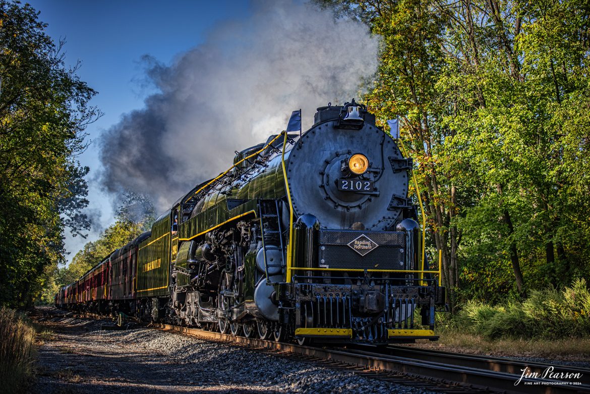 Reading Blue Mountain & Northern Railroad steam locomotive 2102 pulls through the countryside on October 5th, 2024, during its first day of the year of pulling Fall Foliage Excursions, as it heads for Jim Thorpe, Pennsylvania.

According to their website: The Reading Company T-1 class #2102 was built in the Reading’s own locomotive shops in 1945. With drivers of 70” diameter, it weighs 404 tons, and its tender holds up to 26 tons of coal, and up to 19,000 gallons of water. After the Reading Steam era was over, the Reading Company used 2102 for the Reading Rambles on several different excursions. The 2102 has had many different owners since it was retired by the Reading Railroad. It is one of only four to survive. The other remaining locomotives are the 2100, 2101, and 2124.

The Blue Mountain and Reading Railroad purchased the 2102 in 1987, and it ran on the Temple to South Hamburg line into the early 1990’s. Once the Blue Mountain and Reading Railroad became the Reading Blue Mountain & Northern, the 2102 ran over Reading & Northern’s rails for a short time before it was removed from service in the early 1990’s. 

In 2022, steam locomotive 2102 reentered service on the Reading & Northern. The locomotive has been used actively to pull both passenger excursions and revenue freight trains.

Tech Info: Nikon D810, RAW, Nikon 70-300 @ 70mm,  1/640, f/4.5, ISO 180.

#steamtrains #besttrainphotograph #JimPearsonPhotography #RBNRR