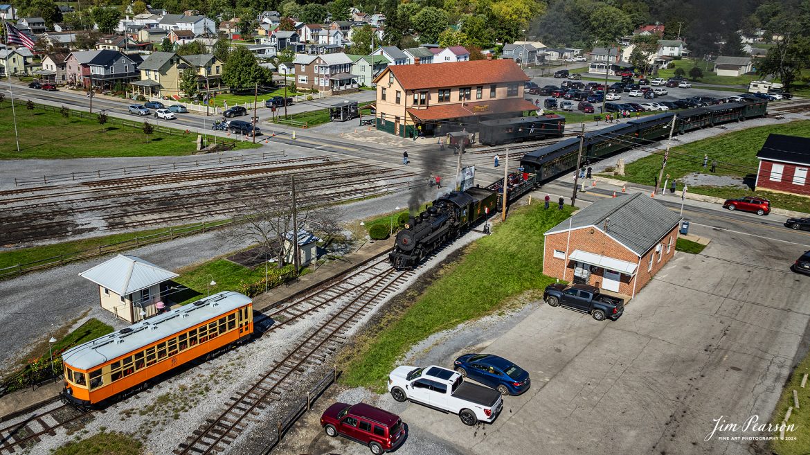 East Broad Top (EBT) steam locomotive #16 pulls a passenger train past the depot as they enter the yard at Rockhill Furnace, Pennsylvania to wye their train for another trip, on October 6th, 2024, on a beautiful fall afternoon.

According to the East Broad Top Website: Locomotive #16 was built in 1916 by the Baldwin Locomotive Works.

Entering the age of modern steam in 1916, the EBT received its first of three large Mikados. Unlike the previous three smaller locomotives, #16 came with superheaters, piston valves, and Southern valve gear. One story mentions #16 pulled 60 empty hoppers from Mt. Union to Rockhill in one train, literally clearing out the yard. #16 underwent an overhaul in 1955 and made only a handful of trips in early 1956 before the railroad shut down an overhaul when the EBT shut down. On February 1, 2023, the locomotive returned to service.

Tech Info: DJI Mavic 3 Classic Drone, RAW, 24mm, f/2.8, 1/2000, ISO 110.

#steamtrains #JimPearsonPhotography #trainsfromtheair #EastBroadTop