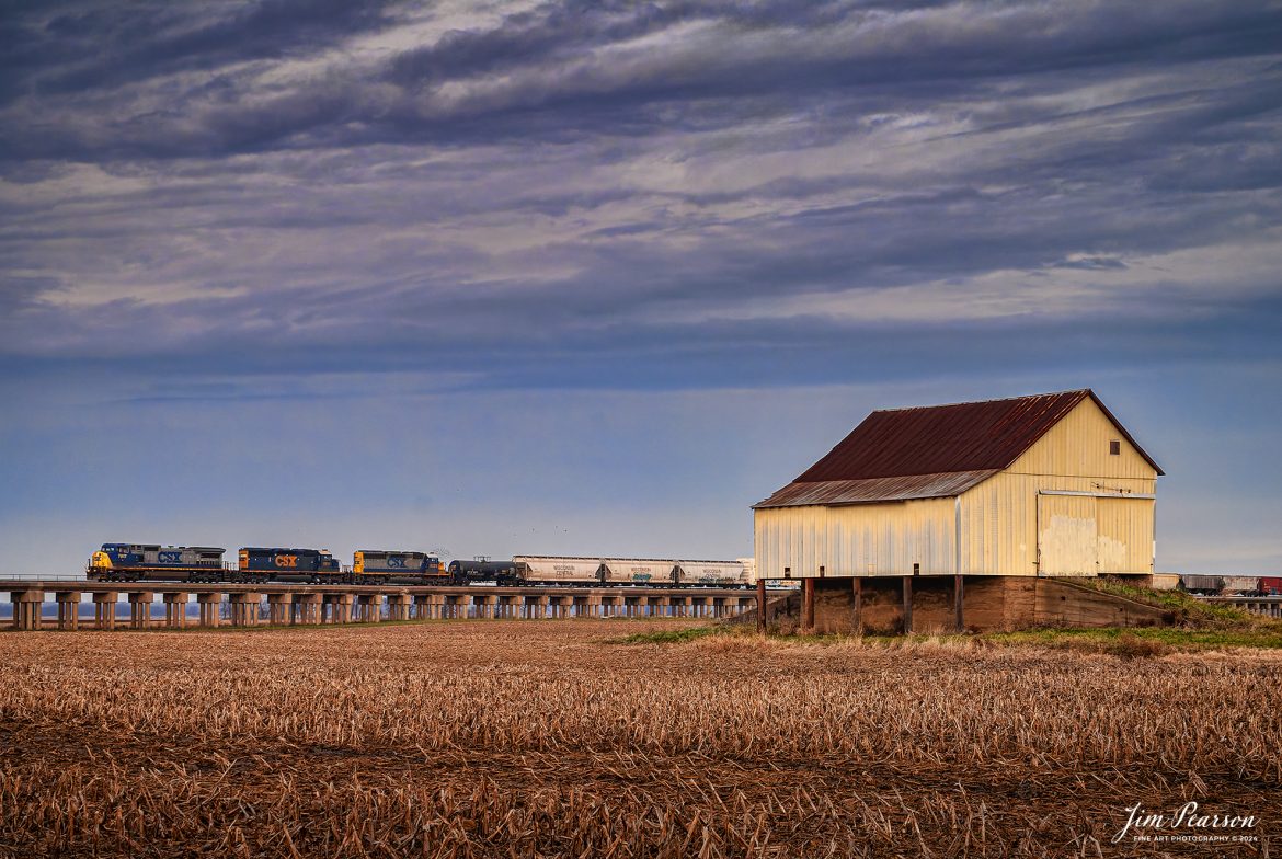 CSXT 9717 leads a southbound freight out of Evansville, Indiana on the viaduct, passing an old barn which is no longer standing, on a beautiful fall morning of November 28th, 2006, on the CSX Henderson Subdivision.

Tech Info: Nikon D200, RAW, Sigma 24-70 @ 40mm,f/8, 1/250, ISO 800.

#photographyoftrains #bestsoldpicture #JimPearsonPhotography