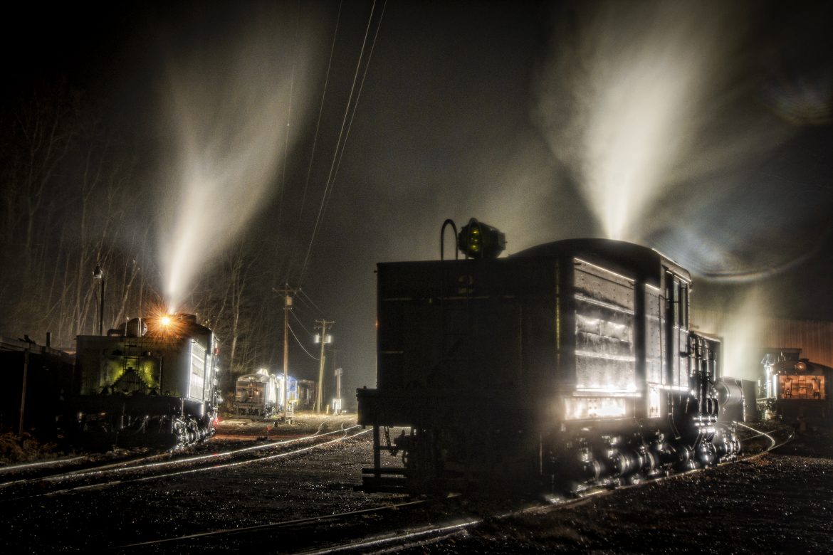 Cass Scenic Railway Shay locomotives 2, (C-80-3), and 11, (C-90-3) sit outside the engine house during a light rain, at the Rail Heritage Photography Weekend, at Cass, West Virginia on the night of November 5th, 2022. 

According to Wikipedia: Cass Scenic Railroad, is an 11-mile (18 km) long heritage railway owned by the West Virginia State Rail Authority and operated by the Durbin and Greenbrier Valley Railroad. The park also includes the former company town of Cass and a portion of the summit of Bald Knob, the highest point on Back Allegheny Mountain.

Founded in 1901 by the West Virginia Pulp and Paper Company (now WestRock), Cass was built as a company town to serve the needs of the men who worked in the nearby mountains cutting spruce and hemlock for the West Virginia Spruce Lumber Company, a subsidiary of WVP&P. At one time, the sawmill at Cass was the largest double-band sawmill in the world. It processed an estimated 1.25 billion board feet (104,000,000 cu ft; 2,950,000 m3) of lumber during its lifetime. In 1901 work started on the 4 ft 8+1⁄2 in (1,435 mm) standard gauge railroad, which climbs Back Allegheny Mountain. 

The railroad eventually reached a meadow area, now known as Whittaker Station, where a logging camp was established for the immigrants who were building the railroad. The railroad soon reached the top of Gobblers Knob, and then a location on top of the mountain known as 'Spruce'. The railroad built a small town at that location, complete with a company store, houses, a hotel, and a doctor's office. Work soon commenced on logging the red spruce trees, which grew in the higher elevations.

Tech Info: Nikon D800, RAW, Nikon 10-24mm @ 24mm, f/9, 30 seconds, ISO 100.

#trainphotography #railroadphotography #trains #railways #trainphotographer #railroadphotographer #jimpearsonphotography #cassscenicrailway #steamtrains