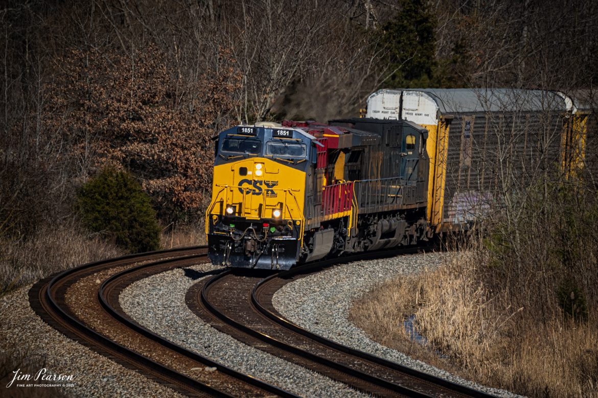 CSX I025 with CSX NC&SL Heritage Unit 1851 leading, heads south into the S curve at Nortonville, Ky, on the CSX Henderson Subdivision, on January 27th, 2025. This train typically runs with autoracks behind the power which contain Tesla's bound for Florida.

According to a CSX Press Release: September 20, 2024 - Railroads have long played a crucial role in shaping the economic and cultural landscapes of the United States. Among these storied lines is the Nashville, Chattanooga, and St. Louis (NC&StL) Railway, a key player in the growth of the Southeast. CSX has unveiled its 19th heritage locomotive, a tribute to the NC&StL Railway, celebrating the rich legacy of a system integral to regional development.

Operating from 1851 to 1957, the NC&StL Railway was a vital freight and passenger route, connecting communities across Tennessee and other Southern states. It facilitated the movement of goods and people, boosting commerce and fostering community development along its routes. The railway's strategic links between Nashville, Chattanooga, and St. Louis significantly contributed to the urban and industrial growth of these cities, supporting industries such as agriculture, coal, and manufacturing.

To honor the historical significance of the NC&StL Railway, CSX introduced the Nashville, Chattanooga, and St. Louis heritage locomotive. This initiative is part of CSX’s broader program to preserve the legacy of railroads that are now part of its extensive network. Each heritage unit is carefully crafted to pay homage to the unique identity and history of its predecessor, featuring colors and designs reminiscent of the original rail lines. 

Tech Info: Nikon Z6ii Mirrorless, RAW, Sigma 150-600 @ 420mm, f/6, 1/2500, ISO 560.

#besttrainphotograph #bestphoto #photographyoftrains #bestsoldpicture #JimPearsonPhotography #csxheritagelocomotive #onecsx