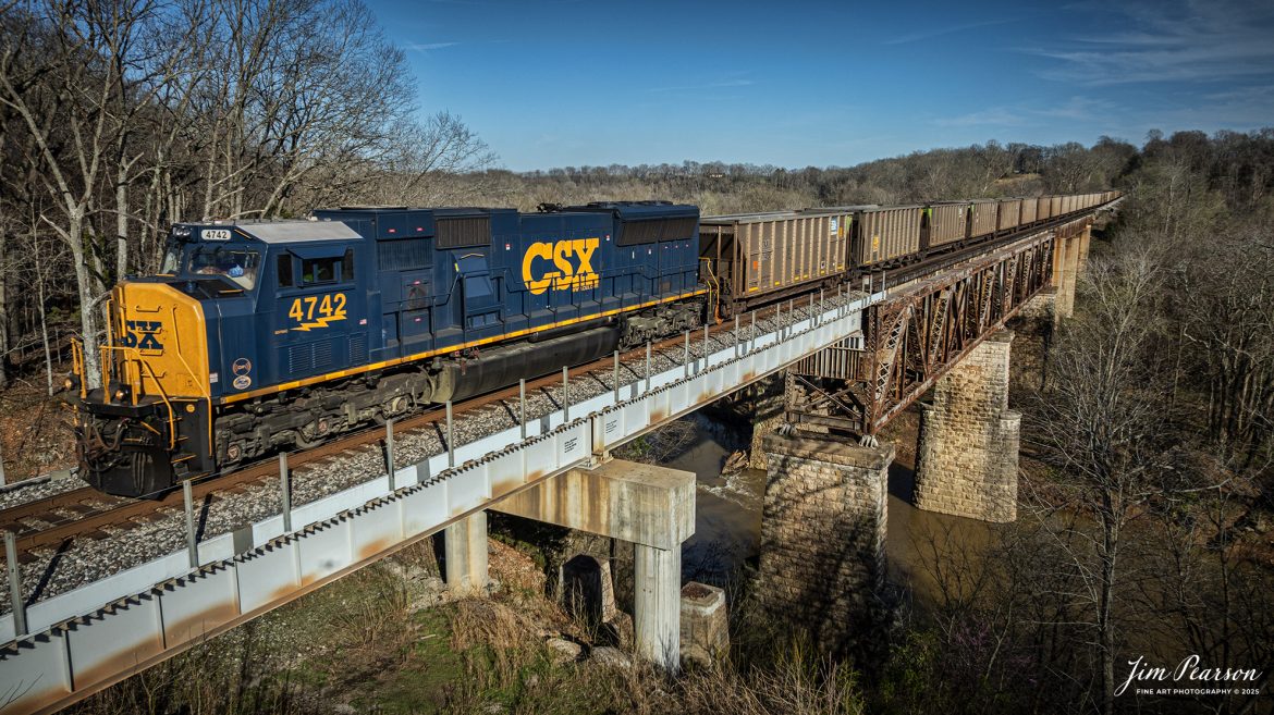 CSX E040 crosses over the Red River at Adams, TN with CSXT 4742 leading a combined empty coal and ethanol train (B622) on March 18th, 2025, on the CSX Henderson Subdivision. 

Tech Info: DJI Mavic 3 Classic Drone, RAW, 22mm, f/2.8, 1/2000, ISO 100.

#railroad #railroads #train, #trains #railway #railway #railtransport #railroadengines #picturesoftrains #picturesofrailways #besttrainphotograph #bestphoto #photographyoftrains #bestsoldpicture #JimPearsonPhotography #trainsfromadrone #csxhendersonsubdivision #onecsx