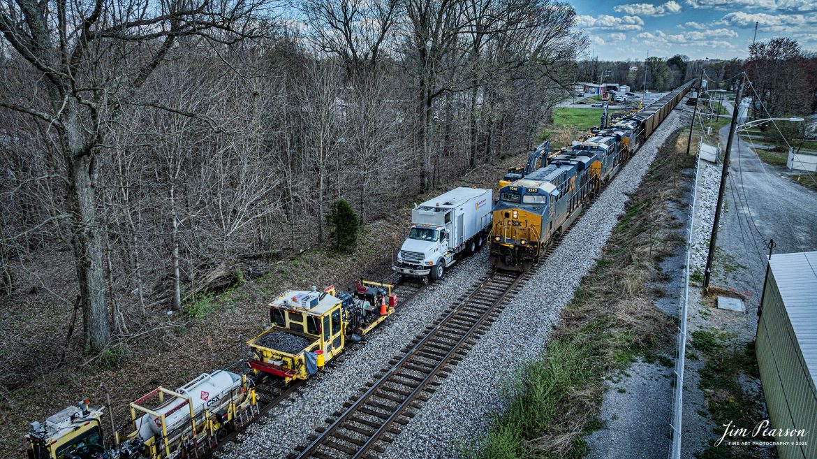 CSXT 3242 passes a long string of maintenance of way equipment in the house track at Hanson, Kentucky on March 26th, 2025, on the CSX Henderson Subdivision as it heads north with empty coal train E320.

Tech Info: DJI Mavic 3 Classic Drone, RAW, 22mm, f/2.8, 1/2000, ISO 340.

#railroad #railroads #train, #trains #railway #railway #railtransport #railroadengines #picturesoftrains #picturesofrailways #besttrainphotograph #bestphoto #photographyoftrains #bestsoldpicture #JimPearsonPhotography #trainsfromadrone #csxhendersonsubdivision #onecsx