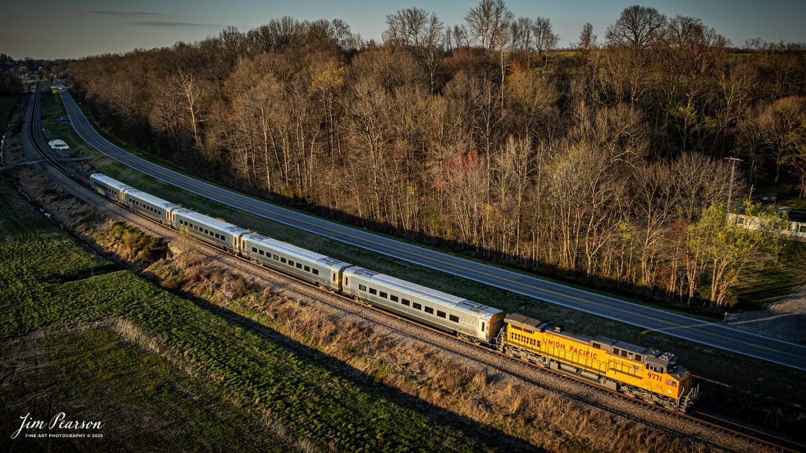 Union Pacific 9771 leads CSX S982 as the heads south out of Sebree, Kentucky as a set of five new passenger cars for Brightline in Florida on March 26th, 2025, on the CSX Henderson Subdivision, in the golden light of the setting sun. 

Unfortunately, the last car in the consist has already been hit by a tagger somewhere along it’s run from California.

According to Wikipedia: Brightline is a privately run intercity rail route between Miami and West Palm Beach, Florida that runs on track owned by Florida East Coast Railway. An extension from West Palm Beach to Orlando International Airport was expected to open in 2023.

Brightline is the only privately owned and operated intercity passenger railroad in the United States. Its development started in March 2012 as All Aboard Florida by Florida East Coast Industries; a Florida real estate developer owned by Fortress Investment Group. Construction began in November 2014 and the route opened in January 2018.

Tech Info: DJI Mavic 3 Classic Drone, RAW, 22mm, f/2.8, 1/500, ISO 140.

#railroad #railroads #train, #trains #railway #railway #railtransport #railroadengines #picturesoftrains #picturesofrailways #besttrainphotograph #bestphoto #photographyoftrains #bestsoldpicture #JimPearsonPhotography #trainsfromadrone #csxhendersonsubdivision #onecsx #brightline #unionpacific