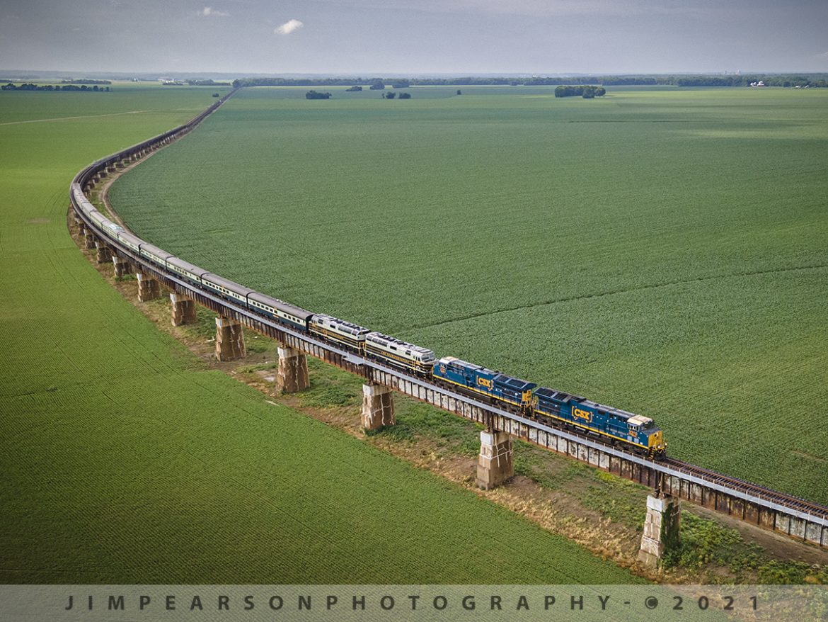 CSX Presidents Special southbound on the Henderson Subdivision

CSX Presidents Passenger train P001 heads south up the viaduct approaching the bridge over the Ohio River at Henderson, Ky from Evansville, IN, with CSX Gevo units 3310, 3271 leading and CSXT 1 & 2 trailing as they pull 11 cars at a little over 1,000 ft long. Not sure, but I heard they had problems with PTC on CSXT 1 & 2 and thats why they had to put the Gevos on the front on June 10th, 2021.

CSX has repainted two of its F40PH locomotives, to be used on its business train, into predecessor Baltimore & Ohio's blue, gray, and black paint scheme. CSX1 is former 9998 (former Amtrak 288) and from what I can find out CSXT 2 is the former F40PH 9993 (former Amtrak 395) but cant really confirm it for sure. The other F40s are expected to be painted in the same scheme in the coming months as they are cycled through the shops.

Tech Info: DJI Mavic Air 2 Drone, RAW, 4.5mm (24mm equivalent lens) f/2.8, 1/500, ISO 100.

#trainphotography #railroadphotography #trains #railways #dronephotography #jimpearsonphotography