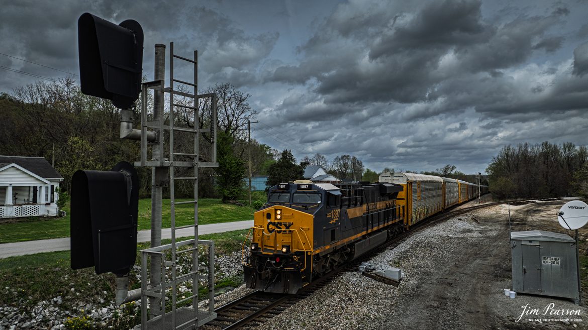 CSX I025 heads south through Mortons Junction at Mortons Gap, Kentucky as CSX Monon Heritage Unit 1897 leads it under dark threatening skies on April 2nd, 2025, on the CSX Henderson Subdivision. The eleven autoracks behind the engine are loaded with Tesla’s bound for Florida and overseas market from what I’m told.

Capturing this engine means I’ve caught all of CSX’s Heritage units except for the Georgia Heritage Unit, and that one is only a matter of time!

According to a CSX Press Release: January 26, 2024 - In a tribute to its rich railroad history, CSX has unveiled its Monon 1897 heritage locomotive, marking the ninth release its ongoing heritage series honoring the company's predecessor railroads.

“The Monon Railroad ran from Chicago down to Louisville but most of it was in Indiana,” explained CSX Carman Jason Merritt, who assisted with the heritage project. “Eventually it merged with the Louisville and Nashville Lines and was later absorbed by CSX.”

The new heritage locomotive emerges fresh from the Class I railroad's paint shop in Waycross, Ga., showcasing a blend of modern and historic aesthetics. The design features the modern CSX design on the head end, transitioning seamlessly into the historic paint scheme and logo of the Monon line. This style reflects the approach taken with previous installations in the CSX heritage series, which often feature the current CSX paint scheme on the nose and the predecessor's scheme on the body.

Tech Info: DJI Mavic 3 Classic Drone, RAW, 22mm, f/2.8, 1/2500, ISO 150.

#railroad #railroads #train, #trains #railway #railway #railtransport #railroadengines #picturesoftrains #picturesofrailways #besttrainphotograph #bestphoto #photographyoftrains #bestsoldpicture #JimPearsonPhotography #trainsfromadrone #csxhendersonsubdivision #onecsx #csxheritageunit