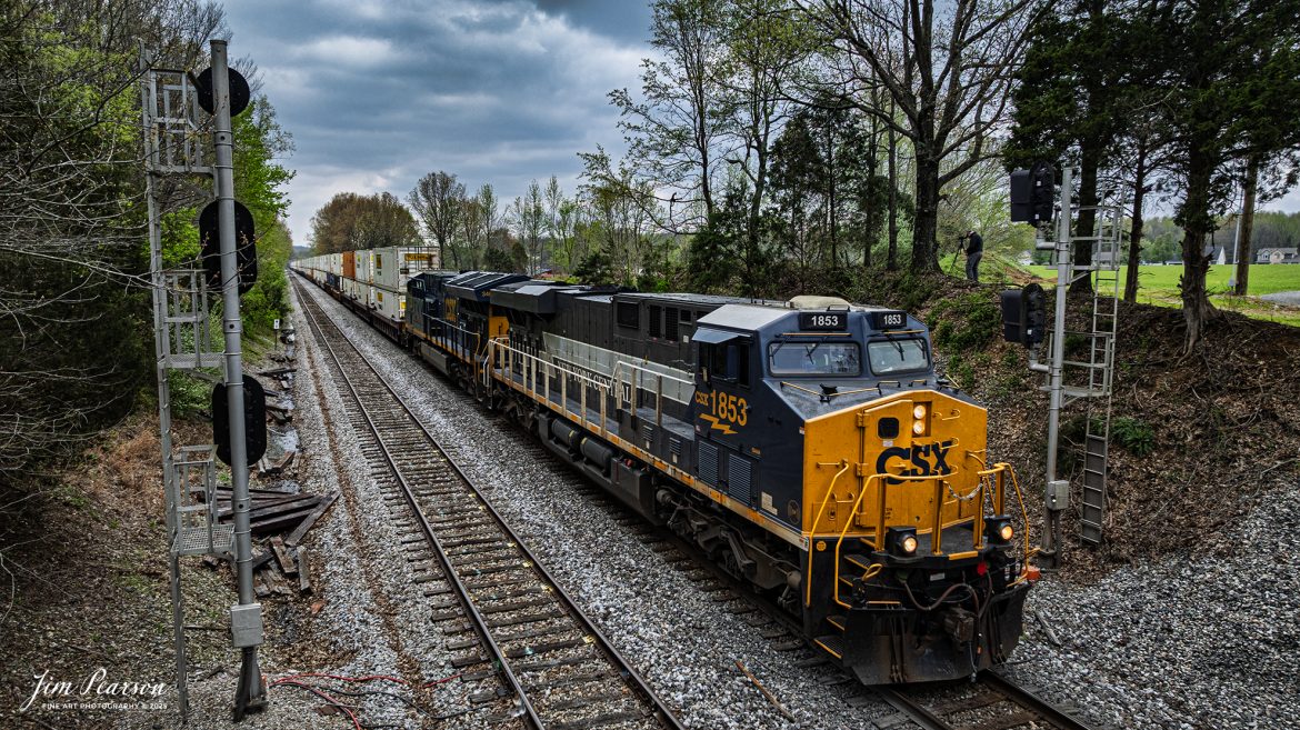 CSX I128, with the New York Central heritage 1877 unit leading passes the north signals at Hanson, Kentucky as it heads north on the CSX Henderson Subdivision, on April 11th, 2025.

According to the CSX Website: January 3, 2024 – A CSX locomotive commemorating the New York Central Railroad has become the eighth unit in CSX’s heritage locomotive fleet.

Designated CSX 1853 in recognition of the year the NYC was founded, the newest heritage unit was repainted in a special design combining the current CSX colors with the traditional gray and white of the NYC system. The NYC heritage unit has been placed into regular revenue service, proudly carrying the NYC colors across the CSX network.

All of the heritage unit paint schemes have been created at the CSX Waycross Locomotive Shop, where employees performed the challenging work of applying the unique designs. Click below to watch a video of CSX 1853 rolling out of the Waycross shop and hear employees describe the 22-day effort to repaint the unit.

At its height, the New York Central system encompassed more than 11,000 track miles and provided vital transportation service between New England and the Midwest. It merged with the Pennsylvania Railroad to become the Penn Central in 1968 and later became part of Conrail.

A majority of former NYC lines were acquired by CSX in 1998, and today CSX employees continue to operate trains across the primary NYC routes that have been carrying freight and supporting the U.S. economy for more than a century.

Tech Info: DJI Mavic 3 Classic Drone, RAW, 24mm, f/2.8, 1/1250, ISO 150.

#railroad #railroads #train, #trains #railway #railway #railtransport #railroadengines #picturesoftrains #picturesofrailways #besttrainphotograph #bestphoto #photographyoftrains #bestsoldpicture #JimPearsonPhotography #trainsfromadrone #csxhendersonsubdivision #onecsx #csxheritageunits
