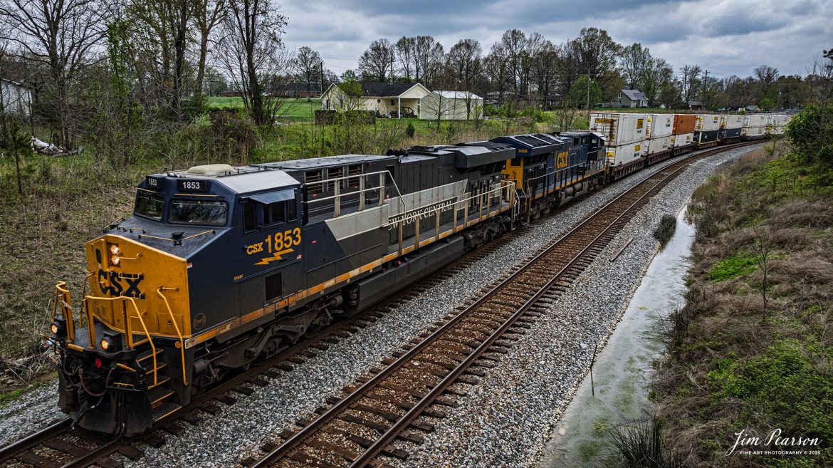 CSX I128, with the New York Central heritage 1877 unit leading at Nortonville, Kentucky as it heads north on the CSX Henderson Subdivision, on April 11th, 2025.

According to the CSX Website: January 3, 2024 – A CSX locomotive commemorating the New York Central Railroad has become the eighth unit in CSX’s heritage locomotive fleet.

Designated CSX 1853 in recognition of the year the NYC was founded, the newest heritage unit was repainted in a special design combining the current CSX colors with the traditional gray and white of the NYC system. The NYC heritage unit has been placed into regular revenue service, proudly carrying the NYC colors across the CSX network.

All of the heritage unit paint schemes have been created at the CSX Waycross Locomotive Shop, where employees performed the challenging work of applying the unique designs. Click below to watch a video of CSX 1853 rolling out of the Waycross shop and hear employees describe the 22-day effort to repaint the unit.

At its height, the New York Central system encompassed more than 11,000 track miles and provided vital transportation service between New England and the Midwest. It merged with the Pennsylvania Railroad to become the Penn Central in 1968 and later became part of Conrail.

A majority of former NYC lines were acquired by CSX in 1998, and today CSX employees continue to operate trains across the primary NYC routes that have been carrying freight and supporting the U.S. economy for more than a century.

Tech Info: DJI Mavic 3 Classic Drone, RAW, 24mm, f/2.8, 1/2500, ISO 140.

#railroad #railroads #train, #trains #railway #railway #railtransport #railroadengines #picturesoftrains #picturesofrailways #besttrainphotograph #bestphoto #photographyoftrains #bestsoldpicture #JimPearsonPhotography #trainsfromadrone #csxhendersonsubdivision #onecsx #csxheritageunits
