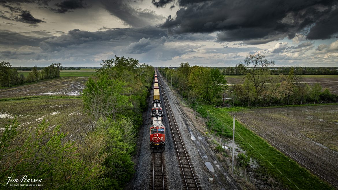 A southbound Canadian National intermodal waits to depart on the main from the south end of Effingham, Illinois on the CN Champagne Subdivision, on April 25th, 2025, under stormy skies.

Tech Info: DJI Mavic 3 Classic Drone, RAW, 24mm, f/2.8, 1/1000, ISO 230.

#railroad #railroads #train, #trains #railway #railway #railtransport #railroadengines #picturesoftrains #picturesofrailways #besttrainphotograph #bestphoto #photographyoftrains #bestsoldpicture #JimPearsonPhotography #trainsfromadrone #unionpacificrailway