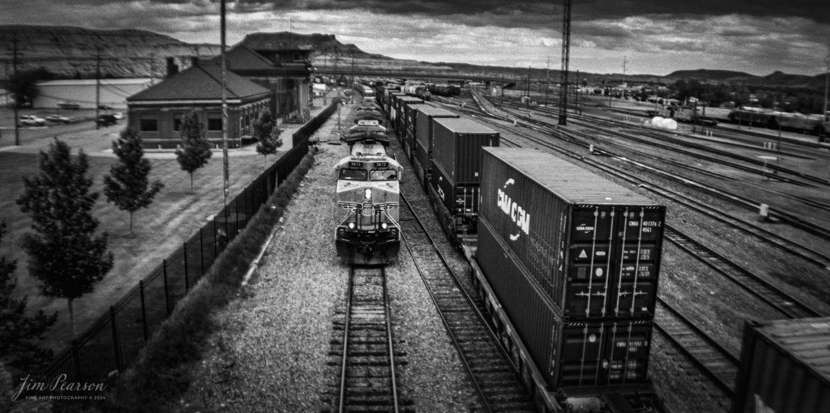 Film Wednesday – Union Pacific 5673 leads an mixed freight westbound on Main 1 along the UP Evanston Subdivision, as it passes the UP Green River Depot at Green River, Wyoming on June 18th, 2023.

According to Wikipedia: Green River station is a former train station in Green River, Wyoming. It was served by the Union Pacific Railroad from its construction to 1971, and by Amtrak from 1971 to 1983 and 1991–1997. The Pioneer was the last train to serve Green River.

The depot is a contributing property to the Green River Downtown Historic District, which was added to the National Register of Historic Places in 2009.

Tech Info: Lomographic Belair X6x12 film Camera, 90mm Lens, f/16, 1/100sec, Ilford 400 B&W Film

#JimPearsonPhotography #filmphotography #lomography #filmphotography