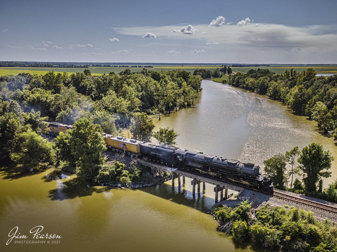 Union Pacifics 4014, the Big Boy, passes over the Black River as it approaches downtown Corning, Arkansas on Friday, August 27th, 2021, as they head north on the UP Hoxie subdivision on its way to Poplar Bluff, AR.

The Big Boy is an articulated 4-8-8-4 steam locomotive which was manufactured by the American Locomotive Company (ALCO) of Schenectady, New York in 1941. There were a total 25 of these giants built and of the eight remaining locomotives this is the only operational one. 

According to Wikipedia: The locomotive operated in revenue service until 1959, when it was donated to the Railway and Locomotive Historical Society in late 1961 and thereafter displayed in Fairplex at the RailGiants Train Museum in Pomona, California. 

In 2013, UP re-acquired the locomotive and launched a restoration project at their Steam Shop in Cheyenne, Wyoming. In May 2019, No. 4014 was operated for the first time after sitting dormant for almost six decades. 

It ran its first excursion, double-headed with Union Pacific 844, three days later on May 4, 2019. Now part of the Union Pacific's heritage fleet, it now operates in excursion service, in addition to hauling revenue freight during ferry moves.

The Big Boy is currently on a month-long tour around the Midwest through, Arkansas, Colorado, Kansas, Illinois, Louisiana, Missouri, Nebraska, Oklahoma, Texas, and Wyoming before heading home to Cheyenne, Wyoming on September 7th. For the route and schedule visit: https://www.up.com/heritage/steam/schedule/index.htm to see if its stopping near you!

Tech Info: Wide Photo: DJI Mavic Air 2 Drone, RAW, 4.5mm (24mm equivalent lens) f/2.8, 1/800, ISO 100, August 27, 2021. 

#trainphotography #railroadphotography #trains #railways #dronephotography #jimpearsonphotography