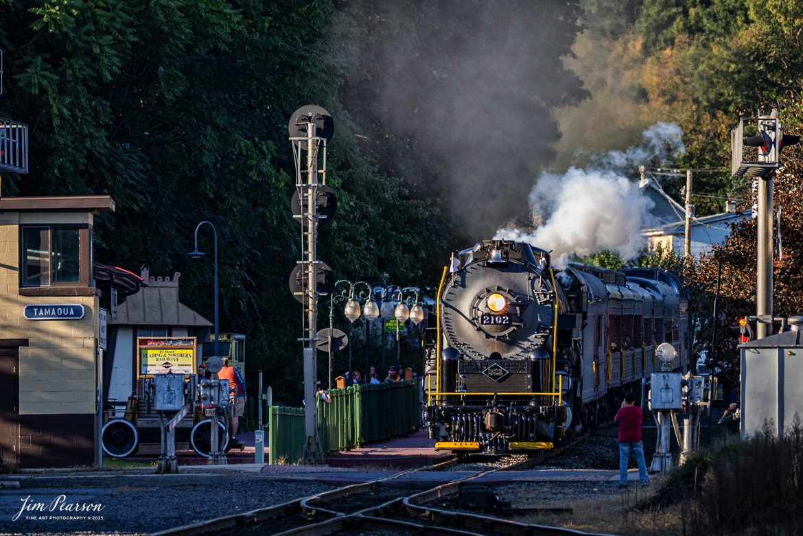 Reading Blue Mountain & Northern Railroad steam locomotive 2102 steams through Tamaqua, PA, while spectators watch and photography the train as it heads back to Port Clinton, Pennsylvania on October 5th, 2024 after taking a trainload of passengers to Jim Thorpe, PA on the first day of the year of Fall Foliage Excursions.

According to their website: The Reading Company T-1 class #2102 was built in the Reading’s own locomotive shops in 1945. With drivers of 70” diameter, it weighs 404 tons, and its tender holds up to 26 tons of coal, and up to 19,000 gallons of water. After the Reading Steam era was over, the Reading Company used 2102 for the Reading Rambles on several different excursions. The 2102 has had many different owners since it was retired by the Reading Railroad. It is one of only four to survive. The other remaining locomotives are the 2100, 2101, and 2124.

The Blue Mountain and Reading Railroad purchased the 2102 in 1987, and it ran on the Temple to South Hamburg line into the early 1990’s. Once the Blue Mountain and Reading Railroad became the Reading Blue Mountain & Northern, the 2102 ran over Reading & Northern’s rails for a short time before it was removed from service in the early 1990’s. 

In 2022, steam locomotive 2102 reentered service on the Reading & Northern. The locomotive has been used actively to pull both passenger excursions and revenue freight trains.

Tech Info: Nikon D810, RAW, Nikon 70-300 @ 240mm, 1/320, f/5.6, ISO 250.

#railroad #railroads #train, #trains #railway #railway #steamtrains #railtransport #railroadengines #picturesoftrains #picturesofrailways #besttrainphotograph #bestphoto #photographyoftrains #bestsoldpicture #JimPearsonPhotography #RBNRR