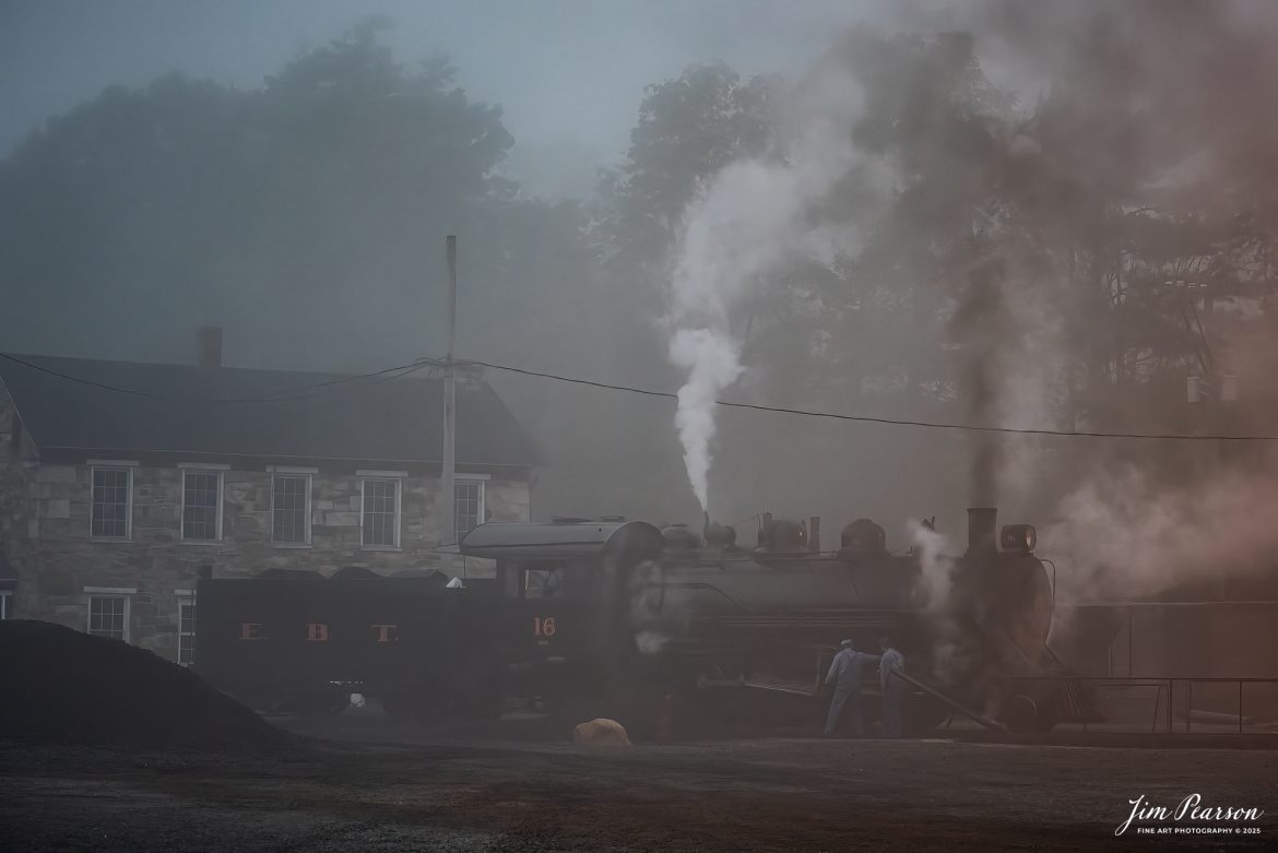 The crew on East Broad Top (EBT) steam locomotive16 prepares the locomotive to start their day, in the early morning fog, from outside the engine house at Rockhill Furnace, Pennsylvania on October 6th, 2024, during the museum’s Friends of the East Broad top event.

According to the East Broad Top Website: Locomotive #16 was built in 1916 by the Baldwin Locomotive Works.

Entering the age of modern steam in 1916, the EBT received its first of three large Mikados. Unlike the previous three smaller locomotives, #16 came with superheaters, piston valves, and Southern valve gear. One story mentions #16 pulled 60 empty hoppers from Mt. Union to Rockhill in one train, literally clearing out the yard. #16 underwent an overhaul in 1955 and made only a handful of trips in early 1956 before the railroad shut down. On February 1, 2023, the locomotive returned to service.

Tech Info: Nikon D810, RAW, Nikon 24-70 @ 70mm, f/2.8, 1/50, ISO 640.

steam locomotive, train, railways, vintage, smoke, green hillside, sunlight, iron bridge, transportation, travel, photography of trains, train photography, Jim Pearson Photography, trending photo, East Broad Top Railroad, steam train