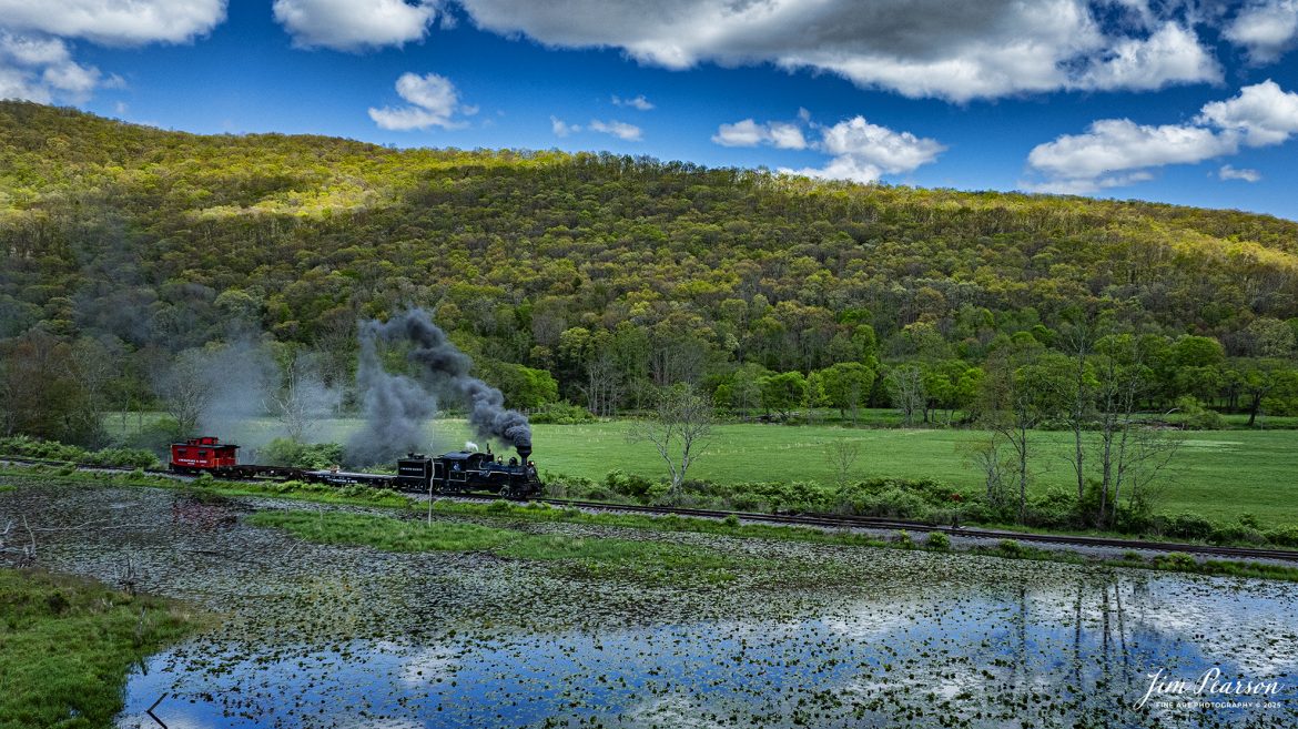 Cass Scenic Railroad Heisler #6 pulls through Hosterman, West Virginia, during the Cass Spring Photographers Special, as it heads back to Cass, West Virginia on May 4th, 2025. 

According to the Mountain Rail West Virginia Website: The Meadow River Lumber No. 6 was built by the Heisler Locomotive Works in Erie, PA, in 1929 for the Bostonia Coal & Clay Products Company of New Bethlehem, PA.

The Heisler was sold to the Meadow River Lumber Company at Rainelle, WV in 1939, where it was rostered as No. 6. She retired from the lumber company in 1965 and was purchased by the purchased it by the state of West Virginia purchased. The engine ran under its own steam from Rainelle to its new home in Cass in December 1966. No. 6 would begin operating on the railroad in 1968. The Heisler is the fastest geared locomotive in the Cass collection.

Tech Info: DJI Mavic 3 Classic Drone, RAW, 24mm, f/6.3, 1/2000, ISO 200.

#railroad #railroads #train, #trains #railway #railway #steamtrains #railtransport #railroadengines #picturesoftrains #picturesofrailways #besttrainphotograph #bestphoto #photographyoftrains #bestsoldpicture #JimPearsonPhotography #trainsfromtheair #trainsfromadrone #steamtrain #casssenicrailway