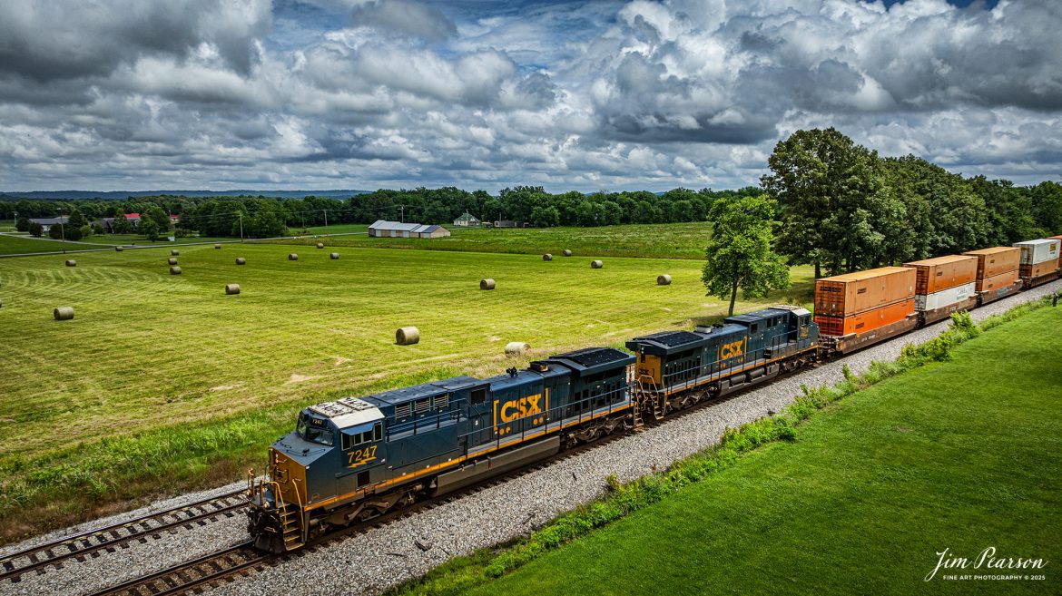 CSXT 7247 leads hot intermodal I128 past a freshly cut hayfield at the north end of the siding at Crofton, Kentucky on June 14th, 2025, on the CSX Henderson Subdivision.

Tech Info: DJI Mavic 3 Classic Drone, RAW, 24mm, f/2.8, 1/3200, ISO 100.

#railroad #railroads #train, #trains #railway #railway #steamtrains #railtransport #railroadengines #picturesoftrains #picturesofrailways #besttrainphotograph #bestphoto #photographyoftrains #bestsoldpicture #JimPearsonPhotography #trainsfromtheair #trainsfromadrone #csxhendersonsubdivision #onecsx