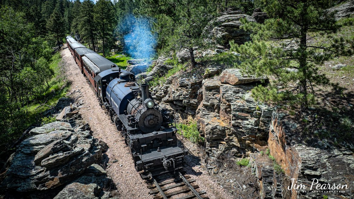 This past week and into next I'm railfanning my way across South Dakota and points between from Kentucky! This is one of many images you'll be seeing in the coming weeks!

The Black Hills Central Railway locomotive 108 heads through one of the many rock cuts through the Black Hills countryside as it makes its third trip of the day from Hill City to Keystone, South Dakota on my birthday, June 26th, 2025. A big shout out to Cory Jakeway for all the help on finding my way around on the railroad and railfanning with me!

According to their website: Locomotive is a 2-6-6-2T articulated tank engine that was built by the Baldwin Locomotives Works in 1926 for the Potlatch Lumber Company. It later made its way to Weyerhaeuser Timber Company and eventually to the Northwest Railway Museum in Snoqualmie, Washington.

The acquisition and subsequent restoration of locomotive 108 completed a more than 20-year goal of increasing passenger capacity which began with the restoration of 110 and the restoration of multiple passenger cars. Both large Mallet locomotives (pronounced “Malley”) can pull a full train of seven authentically restored passenger cars, up from the four cars utilized prior to their addition to the roster.

Tech Info: DJI Mavic 3 Classic Drone, RAW, 24mm, f/2.8, 1/2000, ISO 100.

#railroad #railroads #train, #trains #railway #railway #steamtrains #railtransport #railroadengines #picturesoftrains #picturesofrailways #besttrainphotograph #bestphoto #photographyoftrains #bestsoldpicture #JimPearsonPhotography #trainsfromtheair #trainsfromadrone #1880blackhillsrailway #blackhillsrailway #steamtrains