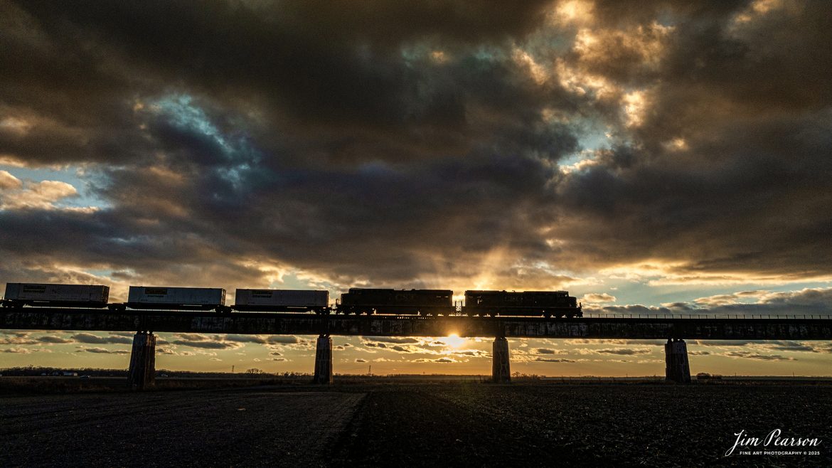 CSX I026 rolls down the viaduct at Rahm, Indiana on the CSX Henderson Subdivision at sunset, December 18th, 2023, on its way north to Evansville, Indiana for a crew change, before heading north to Bedford Park, IL.

Tech Info: DJI Mavic 3 Classic Drone, RAW, 22mm, f/2.8, 1/3200, ISO 170.

#trainphotography #railroadphotography #trains #railways #jimpearsonphotography #trainphotographer #railroadphotographer #csxt #dronephoto #trainsfromadrone #csxhendersonsubdivision