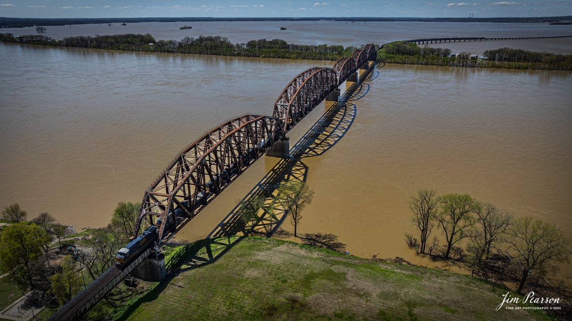 CSX M513 heads south over the flooded Ohio River at Henderson, Kentucky on April 8th, 2025, on the CSX Henderson Subdivision.

This area of Kentucky and southern Indiana got record breaking rainfall throughout the region over a three-day period which resulted in major flooding on both sides of the Ohio River. In the distance you can see the farmlands which have been totally covered by the flooding and the ballast deck out of Evansville was close to being covered, but fortunately it didn’t happen.

Tech Info: DJI Mavic 3 Classic Drone, RAW, 22mm, f/2.8, 1/2000, ISO 100.

#railroad #railroads #train, #trains #railway #railway #railtransport #railroadengines #picturesoftrains #picturesofrailways #besttrainphotograph #bestphoto #photographyoftrains #bestsoldpicture #JimPearsonPhotography #trainsfromadrone #csxhendersonsubdivision #onecsx #flooding