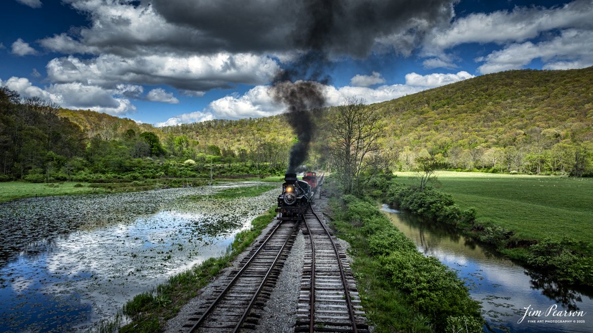 Cass Scenic Railroad Heisler #6 passes the siding at Hosterman, West Virginia, during the Cass Spring Photographers Special, as it heads back to Cass, West Virginia on May 4th, 2025. 

According to the Mountain Rail West Virginia Website: The Meadow River Lumber No. 6 was built by the Heisler Locomotive Works in Erie, PA, in 1929 for the Bostonia Coal & Clay Products Company of New Bethlehem, PA.

The Heisler was sold to the Meadow River Lumber Company at Rainelle, WV in 1939, where it was rostered as No. 6. She retired from the lumber company in 1965 and was purchased by the purchased it by the state of West Virginia purchased. The engine ran under its own steam from Rainelle to its new home in Cass in December 1966. No. 6 would begin operating on the railroad in 1968. The Heisler is the fastest geared locomotive in the Cass collection.

Tech Info: DJI Mavic 3 Classic Drone, RAW, 24mm, f/2.8, 1/2000, ISO 150.

#railroad #railroads #train, #trains #railway #railway #steamtrains #railtransport #railroadengines #picturesoftrains #picturesofrailways #besttrainphotograph #bestphoto #photographyoftrains #bestsoldpicture #JimPearsonPhotography #trainsfromtheair #trainsfromadrone #steamtrain #casssenicrailway