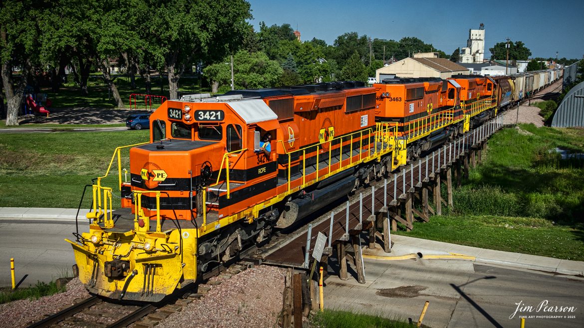 Rapid City, Pierre & Eastern Railroad (RCPE) 3421 crosses a trestle as it leads their train eastbound out of Belle Fourche, as they head for Rapid City, South Dakota on the Black Hills Subdivision, on June 26th, 2025.

According to Wikipedia, the Rapid City, Pierre & Eastern Railroad (reporting mark RCPE) is a Class II freight railroad operating across South Dakota and southern Minnesota in the northern plains of the United States. Portions of the railroad also extend into Wyoming and Nebraska. It is owned and operated by Genesee & Wyoming. The primary commodities shipped are grain, clay, and cement. Operations began on June 1, 2014.

Genesee & Wyoming, a holding company of mostly short line railroads, formed the Rapid City, Pierre & Eastern to acquire the western end of the former Dakota, Minnesota and Eastern Railroad (DM&E) rail line from the Canadian Pacific Railway (CPR). The RCPE and DM&E entered an agreement on January 2, 2014, wherein RCPE would acquire 670 miles of track and 219 miles of trackage rights from the DM&E. The acquisition was completed on May 30, 2014, for $210 million. Most of its employees came from the DM&E.

Tech Info: DJI Mavic 3 Classic Drone, RAW, 24mm, f/5, 1/4000, ISO 100.

#railroad #railroads #train, #trains #railway #railway #railtransport #railroadengines #picturesoftrains #picturesofrailways #besttrainphotograph #bestphoto #photographyoftrains #bestsoldpicture #JimPearsonPhotography #trainsfromtheair #trainsfromadrone #rcperailway #shortlinerailroads #southdakotarailroads