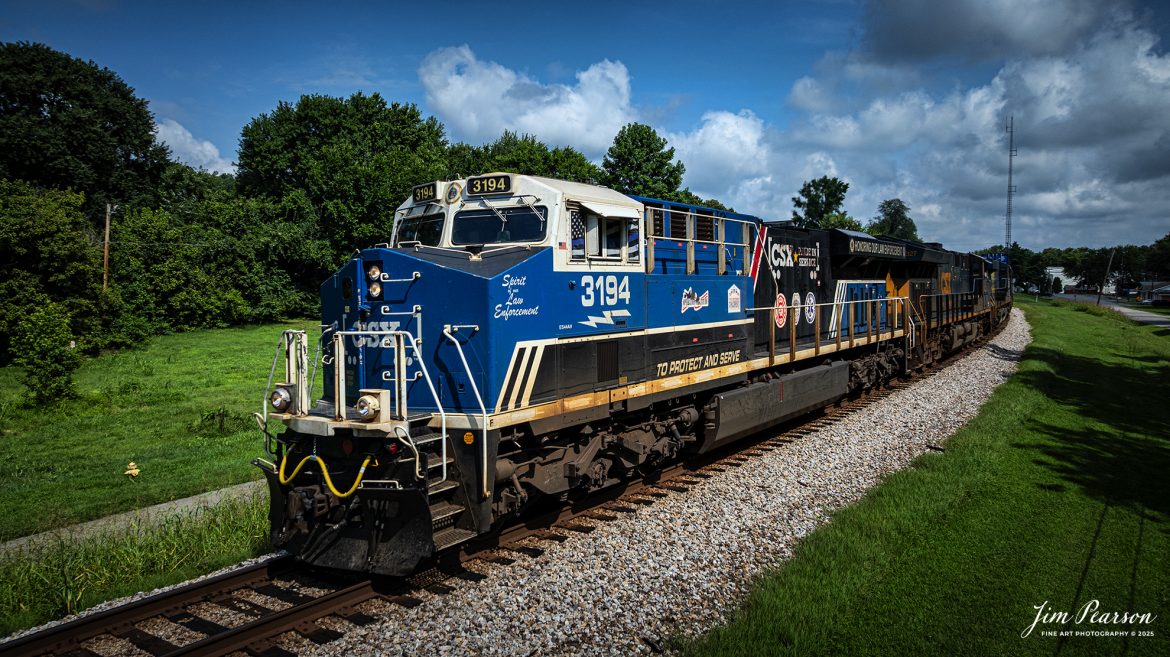 CSX I025 heads south at Mortons Gap, Ky with CSXT 3194 Law Enforcement Unit leading the way, on July 22nd, 2025, on the CSX Henderson Subdivision.

From a CSXT Press Release: CSXT 3194 is being renamed to honor our nation’s police officers who dedicate their lives to serve and protect communities across our network.

“CSX is proud of the employee craftsmanship involved in transforming this locomotive into a special commemorative engine,” says Ed Harris, executive vice president of operations. “This is a moving tribute to the men and women who serve us every day and aligns with CSX’s goal to connect military service members, first responders, and their families to the resources and support they need.”

The Spirit of our Law Enforcement joins our collection of Pride in Service locomotives launched this spring - the Spirit of our Armed Forces and the Spirit of our First Responders. When not actively moving customers - freight, the locomotives are made available for special events along the CSX system - extending our culture of service and commitment from our customers to the communities where we operate.
Tech Info: DJI Mavic 3 Classic Drone, RAW, 22mm, f/2.8, 1/3200, ISO 250.

#railroad #railroads #train, #trains #railway #railway #steamtrains #railtransport #railroadengines #picturesoftrains #picturesofrailways #besttrainphotograph #bestphoto #photographyoftrains #bestsoldpicture #JimPearsonPhotography #trainsfromtheair #trainsfromadrone