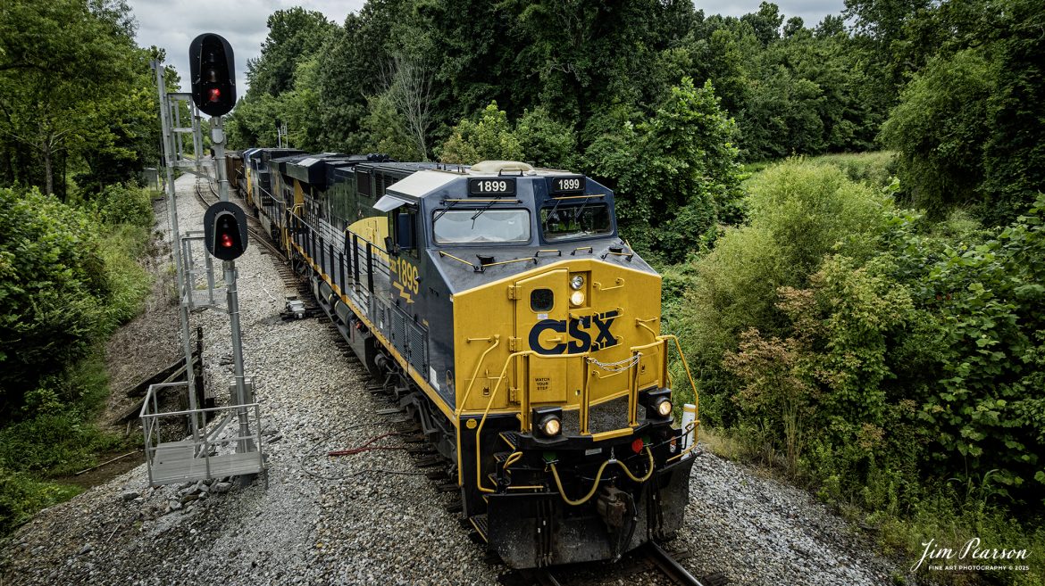 CSX empty coal train E002, with CSX Pere Marquette Heritage Unit 1899 leading, passes the signals at East Diamond on the cutoff at Madisonville, Ky on August 4th, 2025.

According to a CSX Press Release: May 1, 2024 – CSX has introduced the latest addition in its heritage locomotive series, paying homage to the rich history of the Pere Marquette Railroad. This new unit showcases the Pere Marquette’s legacy, dating back to its inception on November 1, 1899.

The Pere Marquette Railroad, operating in the Great Lakes region of the United States and parts of southern Ontario, Canada, derived its name from Jacques Marquette, a notable French Jesuit missionary credited with founding Michigan’s first European settlement in Sault Ste Marie. After years of operation, the company merged with the Chesapeake and Ohio Railway (C&O) on June 6, 1947, eventually becoming part of the renowned CSX network.

The design of the Pere Marquette heritage locomotive was meticulously crafted by employees at the CSX Waycross Locomotive Shop. According to CSX Carman Painter Eric Lee, “We had to measure each stripe precisely and position the words just right to ensure it captured the look of the original design. It took us about four days just to lay out the stripes before we could begin painting.”

A fascinating tidbit related to the history of Pere Marquette is its cameo in the 2004 film “The Polar Express.” The steam locomotive Pere Marquette 1225 served as the inspiration for the train depicted in the movie, with audio recordings of the actual locomotive in operation featured in the film. Interestingly, the locomotive had been donated to Michigan State University and was exhibited near the university’s football stadium. The author of “The Polar Express” book drew inspiration from seeing this locomotive on display during childhood, solidifying its place in popular culture.

Tech Info: DJI Mavic 3 Classic Drone, RAW, 22mm, f/2.8, 1/1600, ISO 260.

#railroad #railroads #train, #trains #railway #railway #steamtrains #railtransport #railroadengines #picturesoftrains #picturesofrailways #besttrainphotograph #bestphoto #photographyoftrains #bestsoldpicture #JimPearsonPhotography #trainsfromtheair #trainsfromadrone #paducahandlouisvillerailway #onecsx #csx