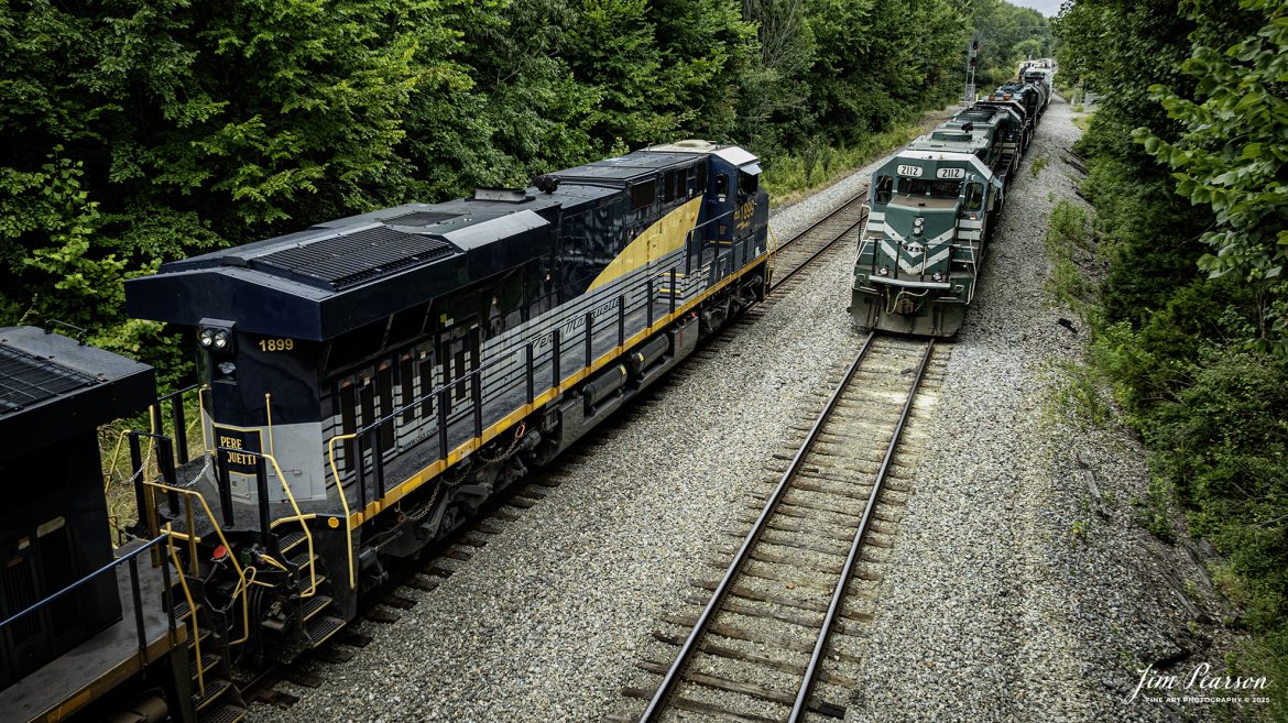 CSX empty coal train E002, with CSX Pere Marquette Heritage Unit 1899 leading, waits on the main at East Diamond, as the Paducah and Louisville Railway local takes the lead heading back to their railroad after interchanging with CSX at Madisonville, Ky on August 4th, 2025.

According to a CSX Press Release: May 1, 2024 – CSX has introduced the latest addition in its heritage locomotive series, paying homage to the rich history of the Pere Marquette Railroad. This new unit showcases the Pere Marquette’s legacy, dating back to its inception on November 1, 1899.

The Pere Marquette Railroad, operating in the Great Lakes region of the United States and parts of southern Ontario, Canada, derived its name from Jacques Marquette, a notable French Jesuit missionary credited with founding Michigan’s first European settlement in Sault Ste Marie. After years of operation, the company merged with the Chesapeake and Ohio Railway (C&O) on June 6, 1947, eventually becoming part of the renowned CSX network.

The design of the Pere Marquette heritage locomotive was meticulously crafted by employees at the CSX Waycross Locomotive Shop. According to CSX Carman Painter Eric Lee, “We had to measure each stripe precisely and position the words just right to ensure it captured the look of the original design. It took us about four days just to lay out the stripes before we could begin painting.”

A fascinating tidbit related to the history of Pere Marquette is its cameo in the 2004 film “The Polar Express.” The steam locomotive Pere Marquette 1225 served as the inspiration for the train depicted in the movie, with audio recordings of the actual locomotive in operation featured in the film. Interestingly, the locomotive had been donated to Michigan State University and was exhibited near the university’s football stadium. The author of “The Polar Express” book drew inspiration from seeing this locomotive on display during childhood, solidifying its place in popular culture.

Tech Info: DJI Mavic 3 Classic Drone, RAW, 22mm, f/2.8, 1/400, ISO 100.

#railroad #railroads #train, #trains #railway #railway #steamtrains #railtransport #railroadengines #picturesoftrains #picturesofrailways #besttrainphotograph #bestphoto #photographyoftrains #bestsoldpicture #JimPearsonPhotography #trainsfromtheair #trainsfromadrone #paducahandlouisvillerailway #onecsx #csx