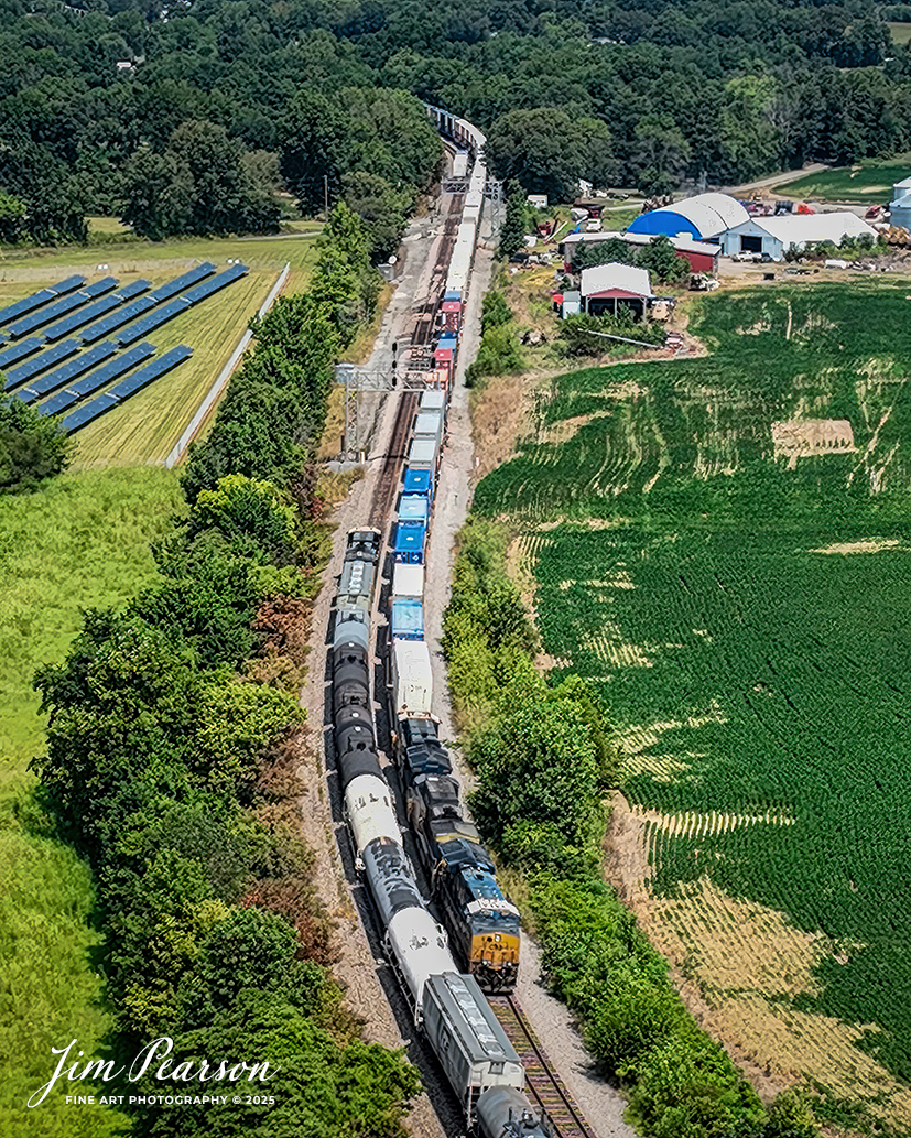 CSX I025 backs past cars on the west track that they set out (Top left track) because of a “hotbox” at the north end of Anaconda to pick up the rest of their train so they can proceed on south at Robards, Kentucky on August 16th, 2025, on the CSX Henderson Subdivision.

Due to the “hotbox” I025 was delayed by two hours and CSX M502 and I128 sat between here and Sebree, Ky waiting to head north through the crossover here at Anaconda. I025 is the hottest train on the Henderson Subdivision and normally all trains get out of their way as they make their way south.

Tech Info: 4K Frame Grab from a DJI Mavic 3 Classic Drone, RAW, 22mm, f/2.8.

#railroad #railroads #train, #trains #railway #railway #steamtrains #railtransport #railroadengines #picturesoftrains #picturesofrailways #besttrainphotograph #bestphoto #photographyoftrains #bestsoldpicture #JimPearsonPhotography #trainsfromtheair #trainsfromadrone #onecsx #csx