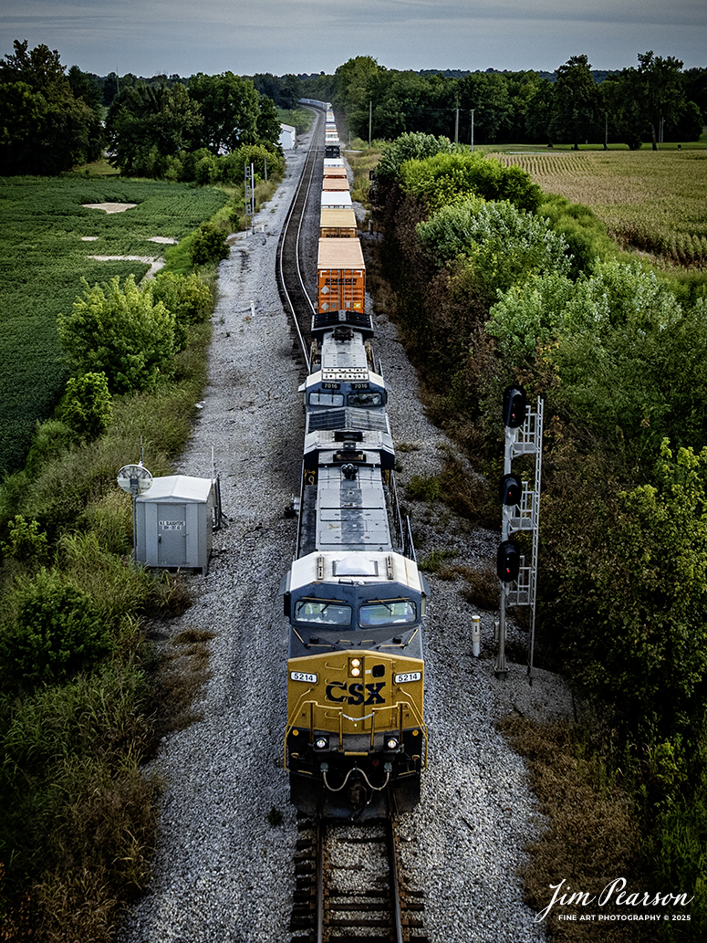 CSXT 5214 leads hot intermodal I026 past the signals at the north end of the siding at Slaughters, Kentucky at it heads north on August 27th, 2025, on the CSX Henderson Subdivision. This train runs between Moncrief Yard at Jacksonville, FL and Bedford Park, IL outside of Chicago, IL.

Tech Info: DJI Mavic 3 Classic Drone, RAW, 22mm, f/2.8, 1/1250, ISO 190

#railroad #railroads #train, #trains #railway #railway #steamtrains #railtransport #railroadengines #picturesoftrains #picturesofrailways #besttrainphotograph #bestphoto #photographyoftrains #bestsoldpicture #JimPearsonPhotography #trainsfromtheair #trainsfromadrone #onecsx #csx