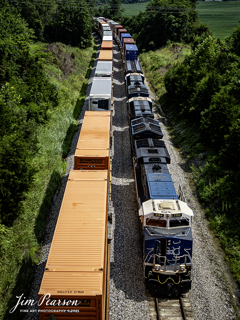 CSX I025 waits in the siding at Kelly, Ky with CSXT 3194 Law Enforcement Unit leading the way, on July 22nd, 2025, on the CSX Henderson Subdivision, as they wait for I128 NB to pass.

From a CSXT Press Release: CSXT 3194 is being renamed to honor our nation’s police officers who dedicate their lives to serve and protect communities across our network.

“CSX is proud of the employee craftsmanship involved in transforming this locomotive into a special commemorative engine,” says Ed Harris, executive vice president of operations. “This is a moving tribute to the men and women who serve us every day and aligns with CSX’s goal to connect military service members, first responders, and their families to the resources and support they need.”

The Spirit of our Law Enforcement joins our collection of Pride in Service locomotives launched this spring - the Spirit of our Armed Forces and the Spirit of our First Responders. When not actively moving customers - freight, the locomotives are made available for special events along the CSX system - extending our culture of service and commitment from our customers to the communities where we operate.

Tech Info: DJI Mavic 3 Classic Drone, RAW, 22mm, f/2.8, 1/2000, ISO 120.

#railroad #railroads #train, #trains #railway #railway #steamtrains #railtransport #railroadengines #picturesoftrains #picturesofrailways #besttrainphotograph #bestphoto #photographyoftrains #bestsoldpicture #JimPearsonPhotography #trainsfromtheair #trainsfromadrone