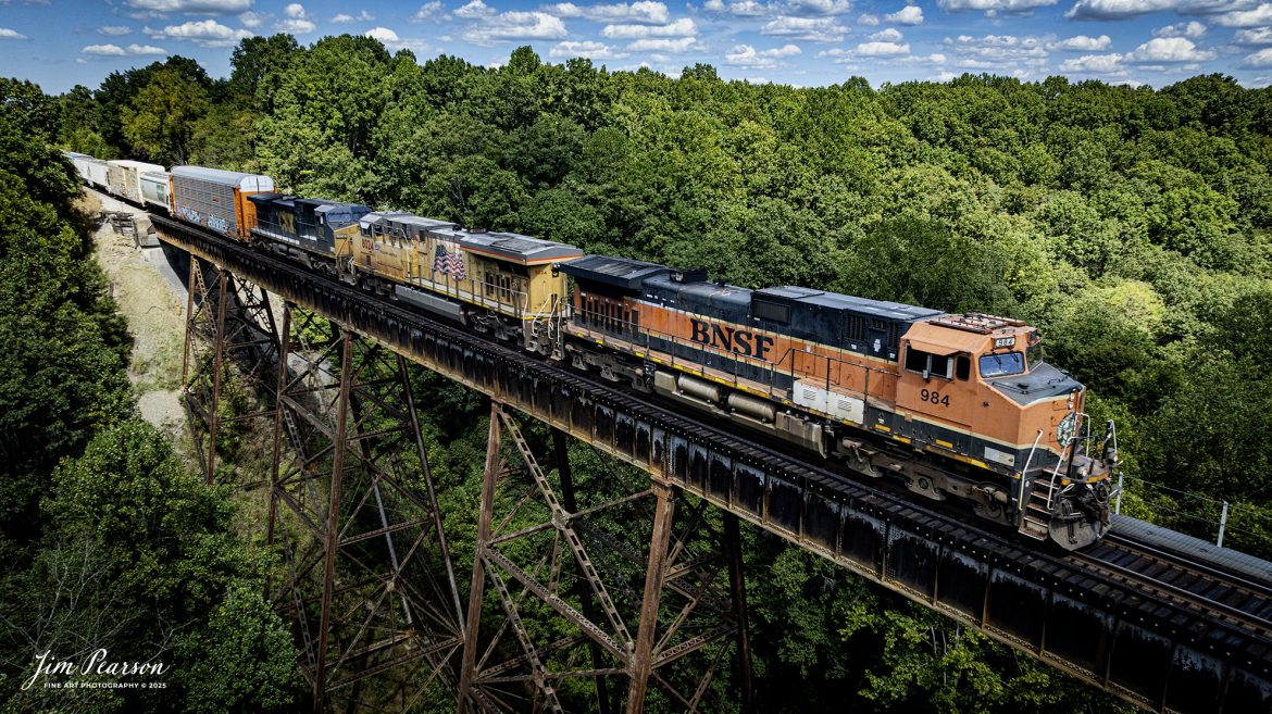 A lash-up of three of the major railroads, BNSF, UP and CSX lead CSX M513 as they head south across Gum Lick Trestle, just north of Kelly, Kentucky on September 1st, 2025, on the CSX Henderson Subdivision.

Tech Info: DJI Mavic 3 Classic Drone, RAW, 22mm, f/2.8, 1/2000, ISO 340

#railroad #railroads #train, #trains #railway #railway #steamtrains #railtransport #railroadengines #picturesoftrains #picturesofrailways #besttrainphotograph #bestphoto #photographyoftrains #bestsoldpicture #JimPearsonPhotography #trainsfromtheair #trainsfromadrone #onecsx #csx #bnsf #unionpacific