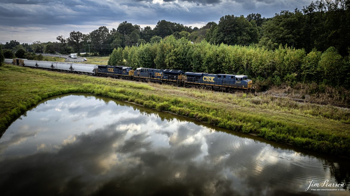CSXT 5337, 3307 and 4737 lead a M500 past a small pond at Poorhouse as they head north at Madisonville, Kentucky, on September 10th, 2025, on the CSX Henderson Subdivision.

Tech Info: DJI Mavic 3 Classic Drone, RAW, 22mm, f/2.8, 1/160, ISO 130

#railroad #railroads #train, #trains #railway #railway #railtransport #railroadengines #picturesoftrains #picturesofrailways #besttrainphotograph #bestphoto #photographyoftrains #bestsoldpicture #JimPearsonPhotography #trainsfromtheair #trainsfromadrone #onecsx #csx CSXT 5337, 3307 and 4737 lead a M500 past a small pond at Poorhouse as they head north at Madisonville, Kentucky, on September 10th, 2025, on the CSX Henderson Subdivision.

Tech Info: DJI Mavic 3 Classic Drone, RAW, 22mm, f/2.8, 1/160, ISO 130

#railroad #railroads #train, #trains #railway #railway #railtransport #railroadengines #picturesoftrains #picturesofrailways #besttrainphotograph #bestphoto #photographyoftrains #bestsoldpicture #JimPearsonPhotography #trainsfromtheair #trainsfromadrone #onecsx #csx
