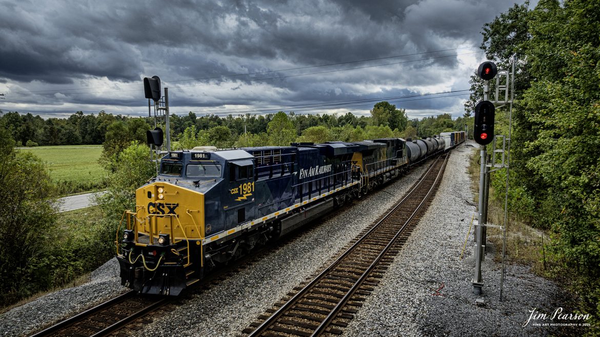 CSXT 1981 Pan Am Railways Heritage Unit leads M512 as they head north on track 2 at Romney, Nortonville, Kentucky, on September 25th, 2025, on the CSX Henderson Subdivision.

According to a CSXT Press Release: November 25, 2024 – CSX has unveiled locomotive No. 1981, the final installment in its series of heritage locomotives, honoring Pan Am Railways. The unit is the 21st and final creation by the Waycross Paint Shop to celebrate the predecessor railroads that form today’s CSX network.

Pan Am Railways, formerly known as Guilford Transportation, was established in 1981 and operated across northern New England, spanning from Maine to New York. It joined the CSX family in 2022 following a purchase agreement.

The heritage series required extra care and precision, according to CSX carman painter Albert Bussey. “It’s always special working on the heritage units,” Bussey said. “Like always, we try to take a little bit of extra care and time in order to do these perfectly.”

All 21 heritage units are not just displays of craftsmanship but active locomotives performing daily duties throughout CSX’s 26-state rail network. The dedication behind their creation reflects the artistry of the team at the Waycross Paint Shop.

The completion of locomotive No. 1981 stands as a tribute to the history of Pan Am Railways and the pride shared by CSX employees. As CSX approaches its 200th anniversary in 2027, these heritage locomotives symbolize the company’s enduring legacy and its dedication to innovation and service.

Tech Info: DJI Mavic 3 Classic Drone, RAW, 22mm, f/2.8, 1/1250, ISO 140

#railroad #railroads #train, #trains #railway #railway #railtransport #railroadengines #picturesoftrains #picturesofrailways #besttrainphotograph #bestphoto #photographyoftrains #bestsoldpicture #JimPearsonPhotography #trainsfromtheair #trainsfromadrone #onecsx #csx
