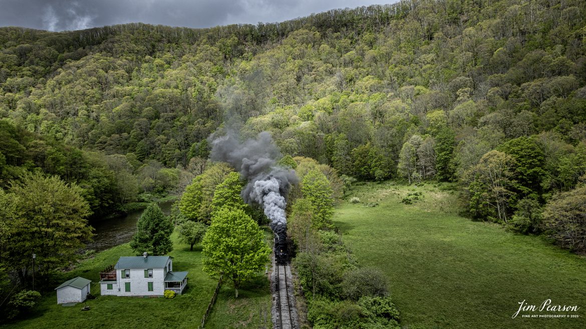 Cass Scenic Railroad Heisler #6 pulls through the countryside passing a small white house at milepost 92 on the way to Durban, West Virginia, during the Cass Spring Photographers Special, out of Cass, West Virginia on May 4th, 2025. 

According to the Mountain Rail West Virginia Website: The Meadow River Lumber No. 6 was built by the Heisler Locomotive Works in Erie, PA, in 1929 for the Bostonia Coal & Clay Products Company of New Bethlehem, PA.

The Heisler was sold to the Meadow River Lumber Company at Rainelle, WV in 1939, where it was rostered as No. 6. She retired from the lumber company in 1965 and was purchased by the purchased it by the state of West Virginia purchased. The engine ran under its own steam from Rainelle to its new home in Cass in December 1966. No. 6 would begin operating on the railroad in 1968. The Heisler is the fastest geared locomotive in the Cass collection.

Tech Info: DJI Mavic 3 Classic Drone, RAW, 24mm, f/6.3, 1/1600, ISO 100.

#railroad #railroads #train, #trains #railway #railway #steamtrains #railtransport #railroadengines #picturesoftrains #picturesofrailways #besttrainphotograph #bestphoto #photographyoftrains #bestsoldpicture #JimPearsonPhotography #trainsfromtheair #trainsfromadrone #steamtrain #casssenicrailway