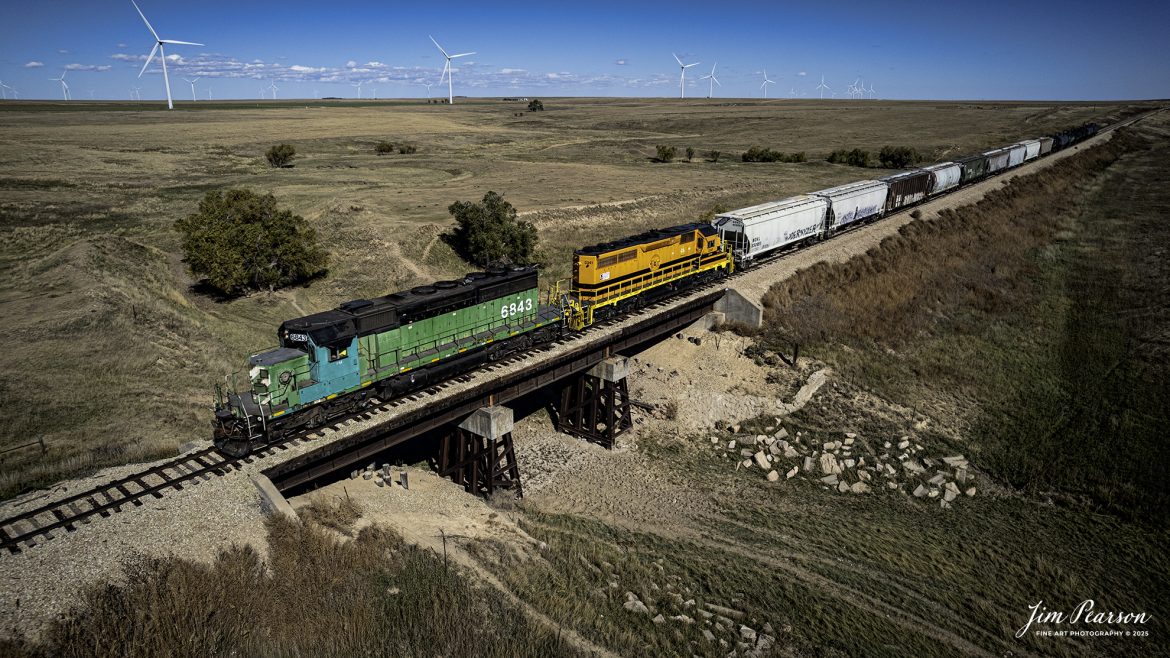 Kyle Regional Railroad 6843 with second out Buffalo and Pittsburgh locomotive 3341 head Westbound at Arriba, CO on the Goodland Subdivision. I’m told that it’s rare to catch trains along this short line so I’m glad it happened!

The Kyle Railroad (reporting mark KYLE) is a regional railroad line that runs from North Central Kansas into Eastern Colorado. It is based in Phillipsburg, Kansas and runs on 508 miles (818 km) of track, mostly the former Chicago, Rock Island and Pacific Railroad's Chicago to Denver main line. The Kyle was owned by RailAmerica from 2002 to 2012. 

Genesee & Wyoming Inc. bought RailAmerica in late 2012. As of 2024, KYLE holds 508 total miles (89 in Colorado and 419 in Kansas), has a maximum capacity of 286,000 gross pounds per railcar. KYLE also has two interchanges with two railroads: BNSF at Courtland, Kansas and Concordia, Kansas, and Union Pacific at Limon, Colorado and Salina, Kansas.

Tech Info: DJI Air 2S Drone, RAW, 22mm, f/2.8, 1/3000, ISO 100

#trains #railway #JimPearsonPhotography #trainsfromadrone #regional Railroad
