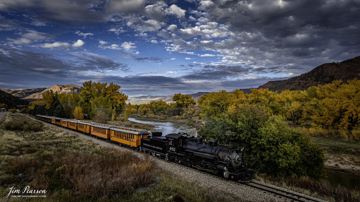 Durango and Silverton Narrow Gauge Railroad locomotive 482 leads the daily passenger train as it passes the Animas River on the way back to Durango, Colorado on October 22nd. 2025.
D&SNG No. 482 is a K-36 class 2-8-2 "Mikado" type narrow gauge steam locomotive. It was originally built by the Baldwin Locomotive Works in 1925 for the Denver & Rio Grande Western Railroad (D&RGW) and is now preserved as a permanent resident of the Durango & Silverton Narrow Gauge Railroad (D&SNG) in Durango, CO.
The Durango and Silverton Narrow Gauge Railroad, often abbreviated as the D&SNG, is a 3 ft (914 mm) narrow-gauge heritage railroad that operates on 45.2 miles (72.7 km) of track between Durango and Silverton, in the U.S. state of Colorado. The railway is a federally designated National Historic Landmark and was also designated by the American Society of Civil Engineers as a National Historic Civil Engineering Landmark in 1968.
The route was originally opened in 1882 by the Denver and Rio Grande Railroad (D&RG) to transport silver and gold ore mined from the San Juan Mountains. The line was the "San Juan" extension of the D&RG 3 ft (914 mm) narrow-gauge line from Antonito, Colorado, to Durango. The last train to operate into Durango from the east was on December 6, 1968.
The line from Durango to Silverton has run continuously since 1881, although it is now a tourist and heritage line hauling passengers, and is one of the few places in the US which has seen continuous use of steam locomotives.
Tech Info: DJI Air 2S Drone, RAW, 22mm, f/2.8, 1/800, ISO 100
#trains #railway #JimPearsonPhotography #trainsfromadrone #steamtrains #D&SNG